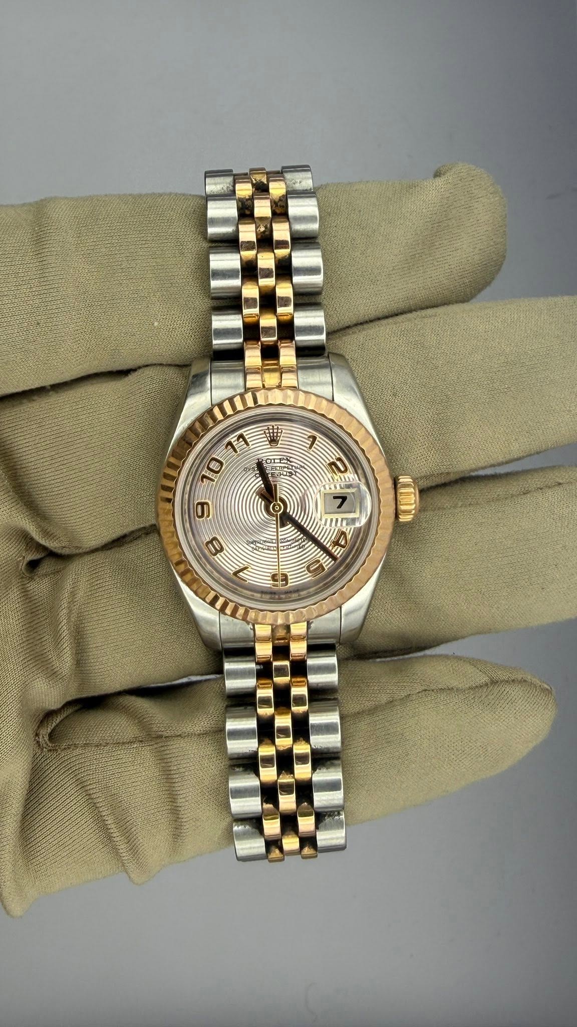 May be an image of wrist watch and text
