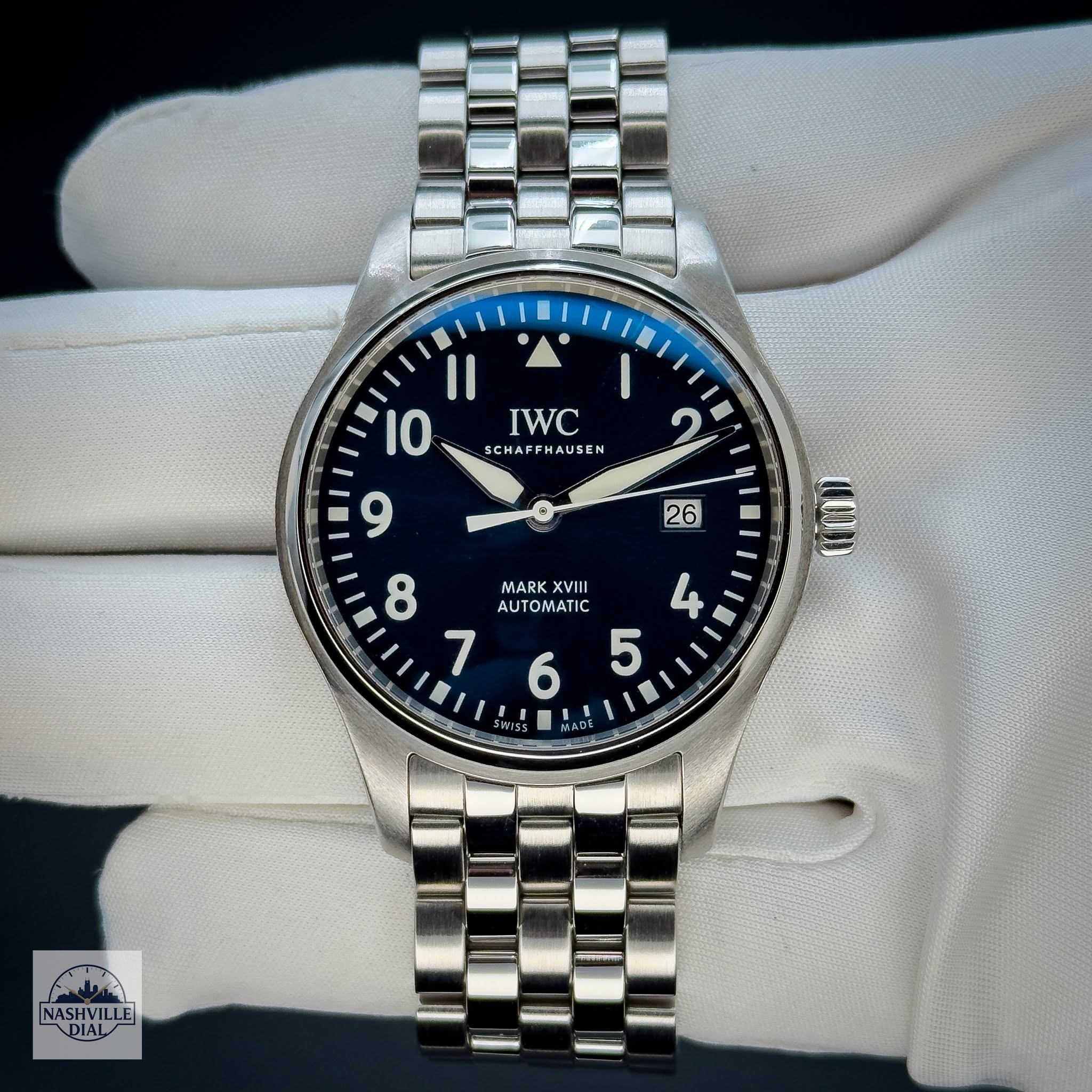 May be an image of wrist watch and text that says 'IWC SCHA SCHAFFHAUSEN SCHAFF AUSEN و 26 Il 10 9 8 MARK XVIII AUTOMATIC V 7 5 COIID 6 RS5 തകට م ASHVII DIAL'
