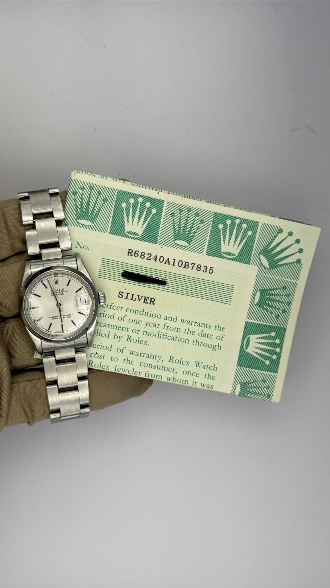 May be an image of wrist watch, money, ticket stub and text that says 'No. د WIIN R68240A10B7835 0B7835 erfect condition and from warrants the SILVER riod do one year lied…