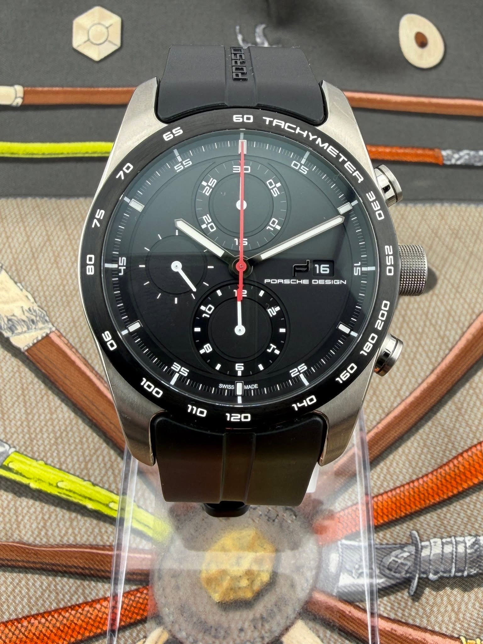 May be an image of wrist watch and text that says '70 55 60 ם "ር TACHYMETER TER 05 OS 330 75 dP D ග T 80 16 PORSCHE DESIGN 2 O 250 በጦ SWISS 25 MADE '