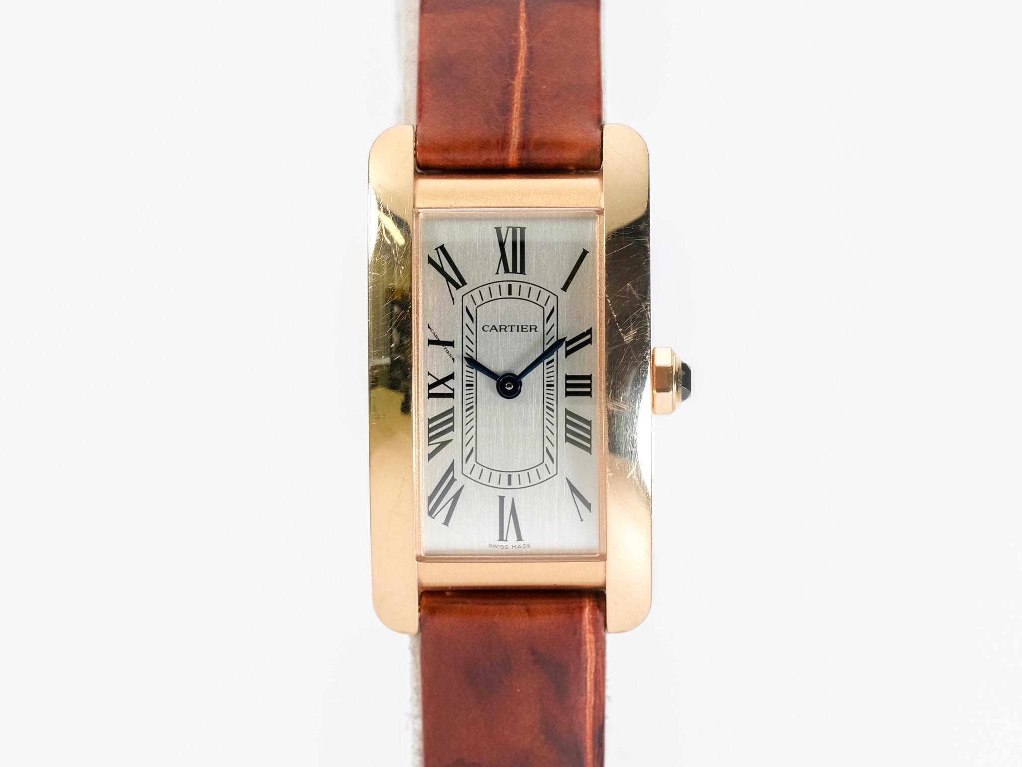 May be an image of wrist watch, leather and text