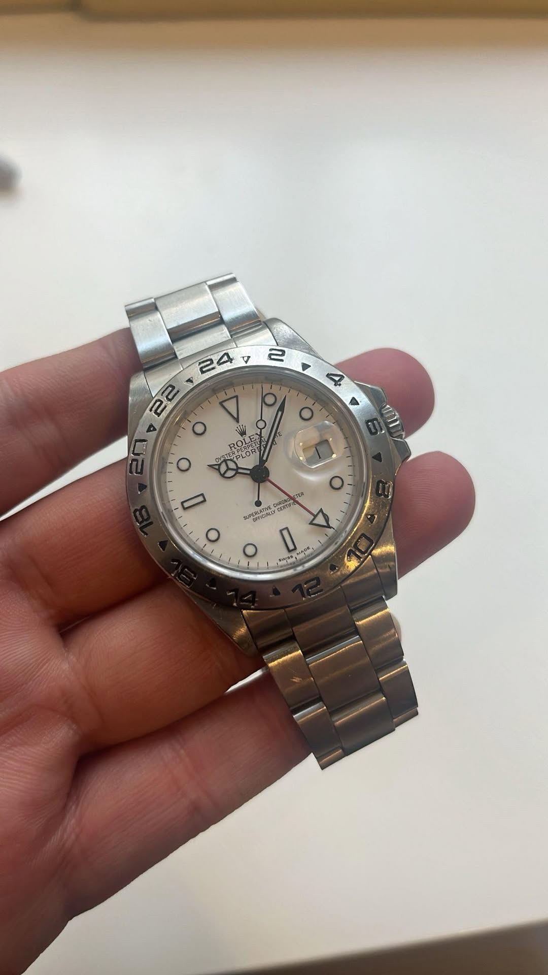 May be an image of wrist watch and text