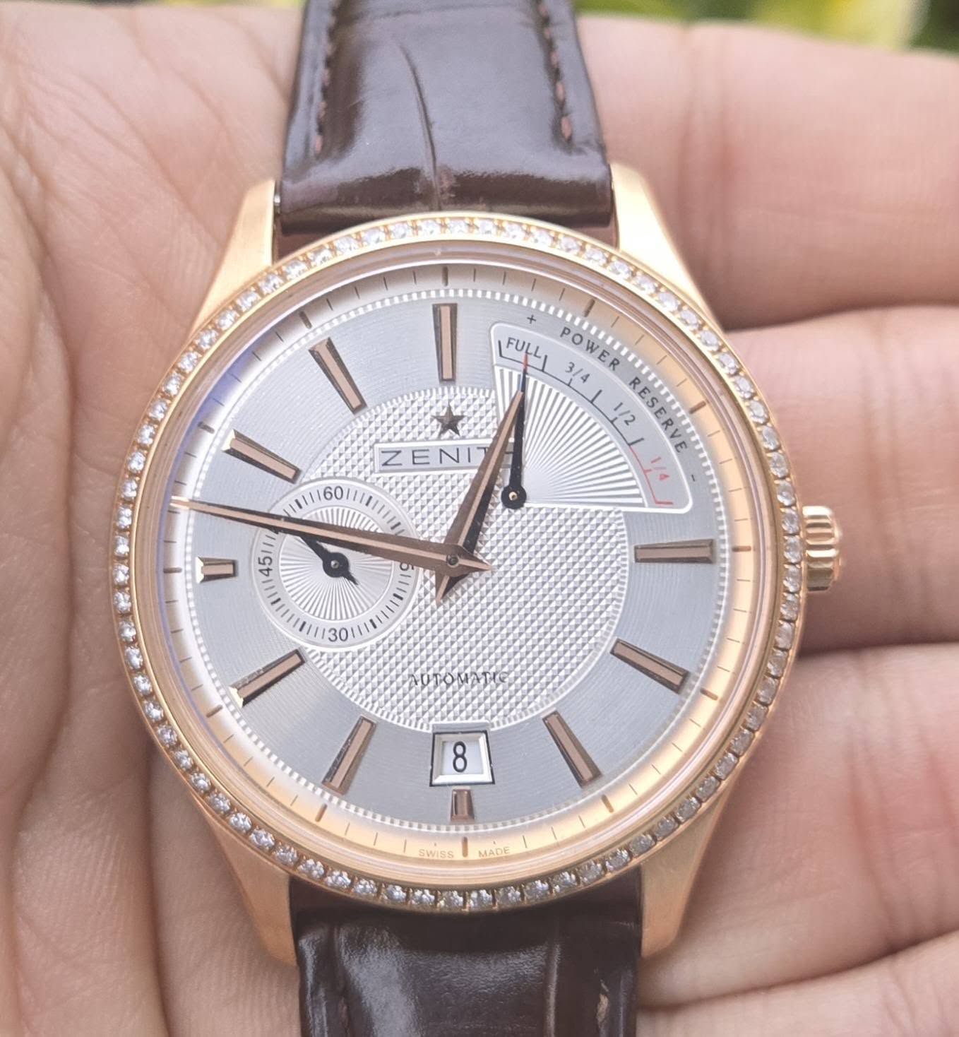 May be an image of wrist watch and text that says 'I FULL POWER HER POWER SINUIT Ep 3/4 1/2 F e ZENI የክዕስስር = 8 A SWISS MADE'