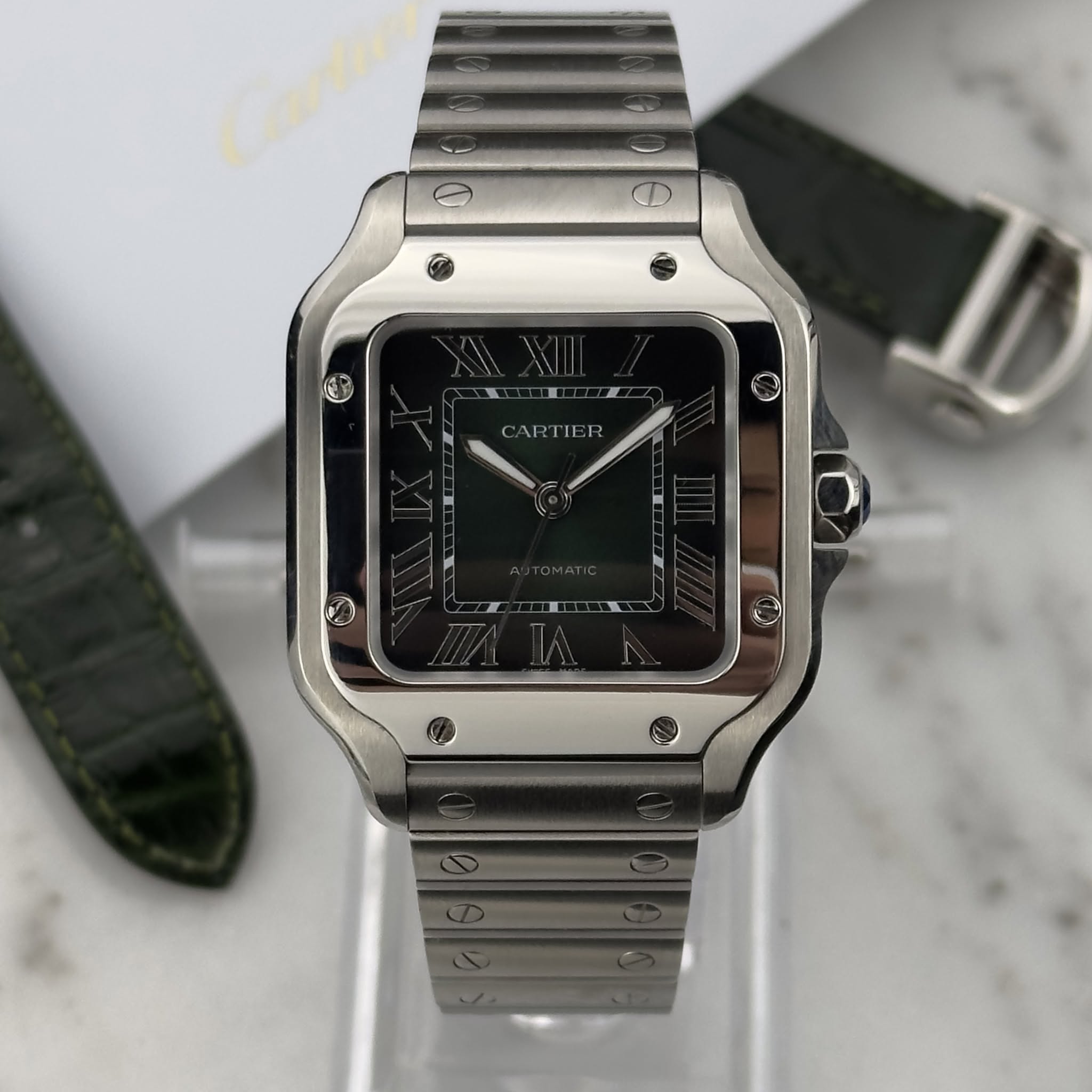May be an image of wrist watch and text that says 'اسم CARTIER'