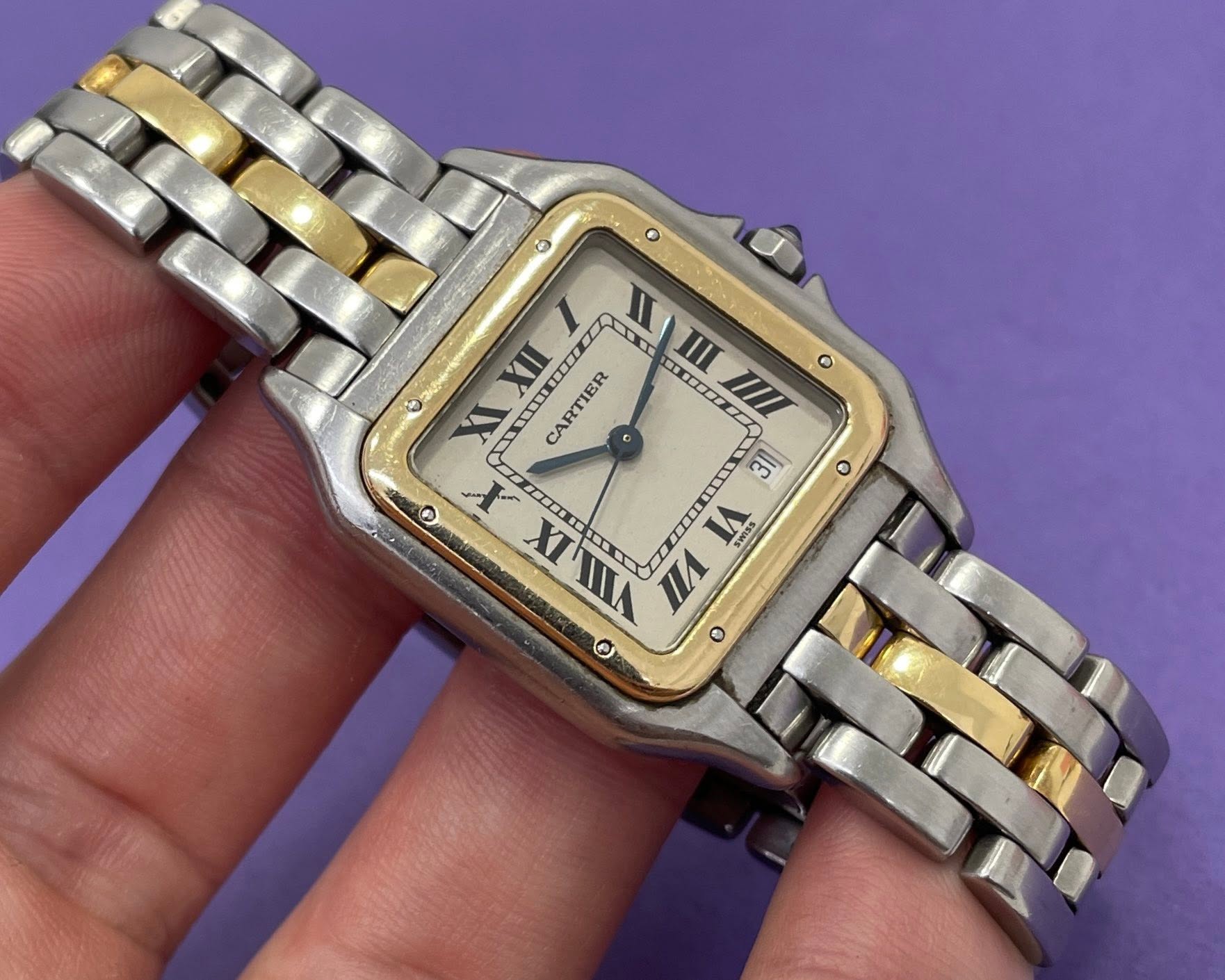 May be an image of wrist watch and text