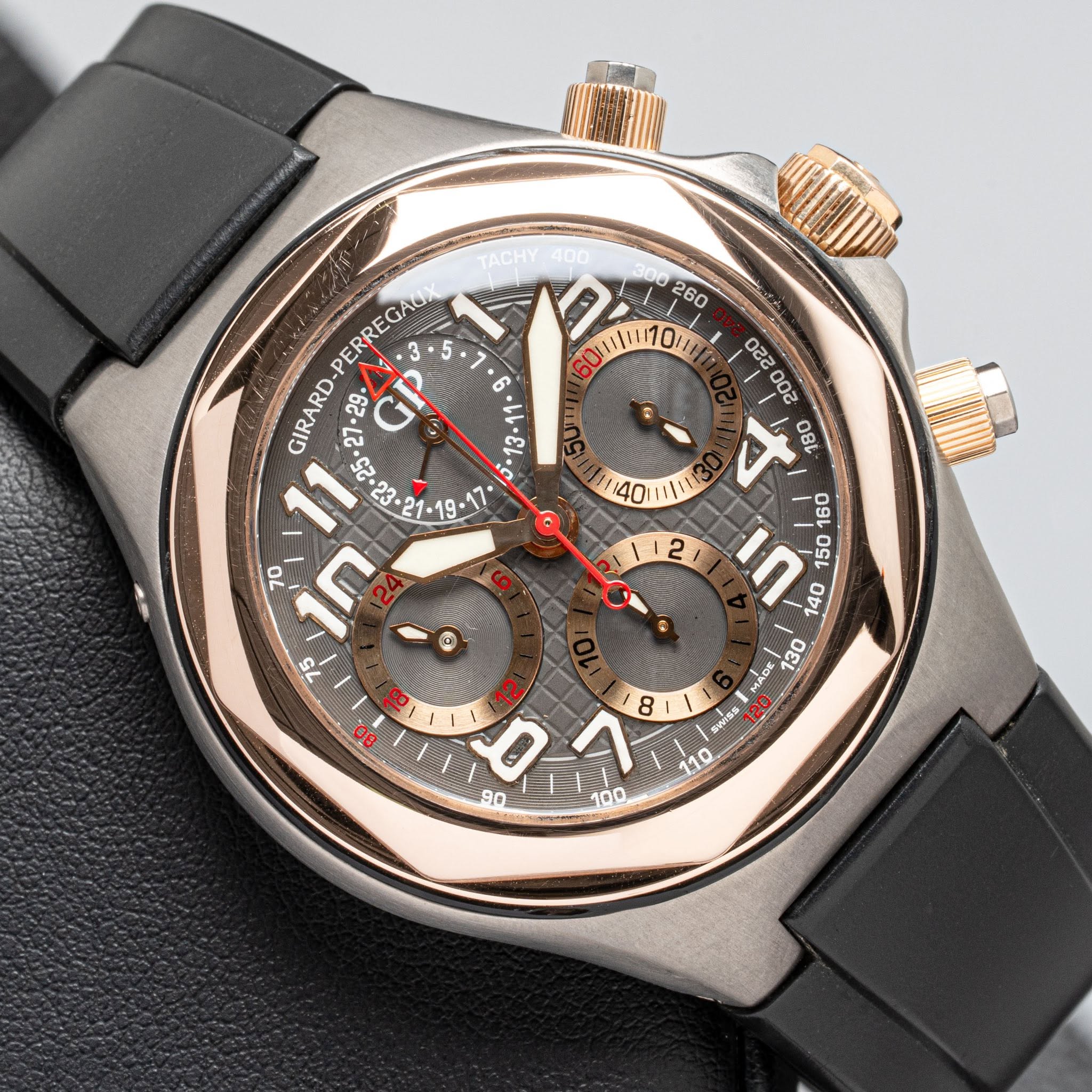 May be an image of wrist watch and text that says 'TACHY / הןקווט ווס0ויוויי PERREGAD GIRARD- .27-29 29 GP • ቀ/ 1-19 70 በ / MADE 130 SWISS 110 2L 8 90 I1 100'