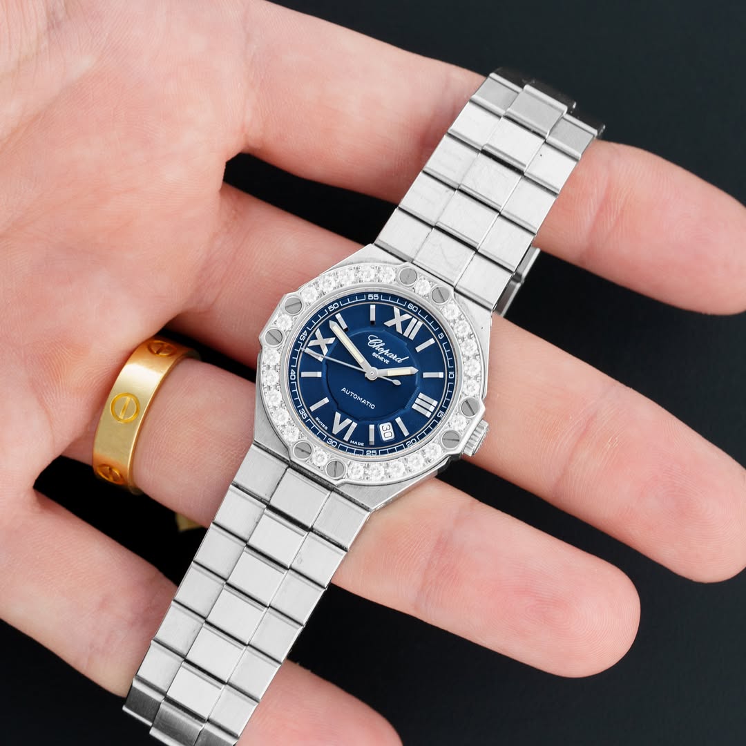 May be an image of wrist watch, strap, timer and text