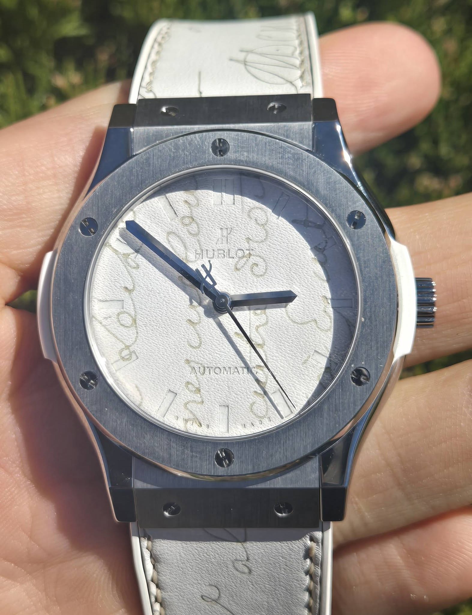 May be an image of wrist watch and text