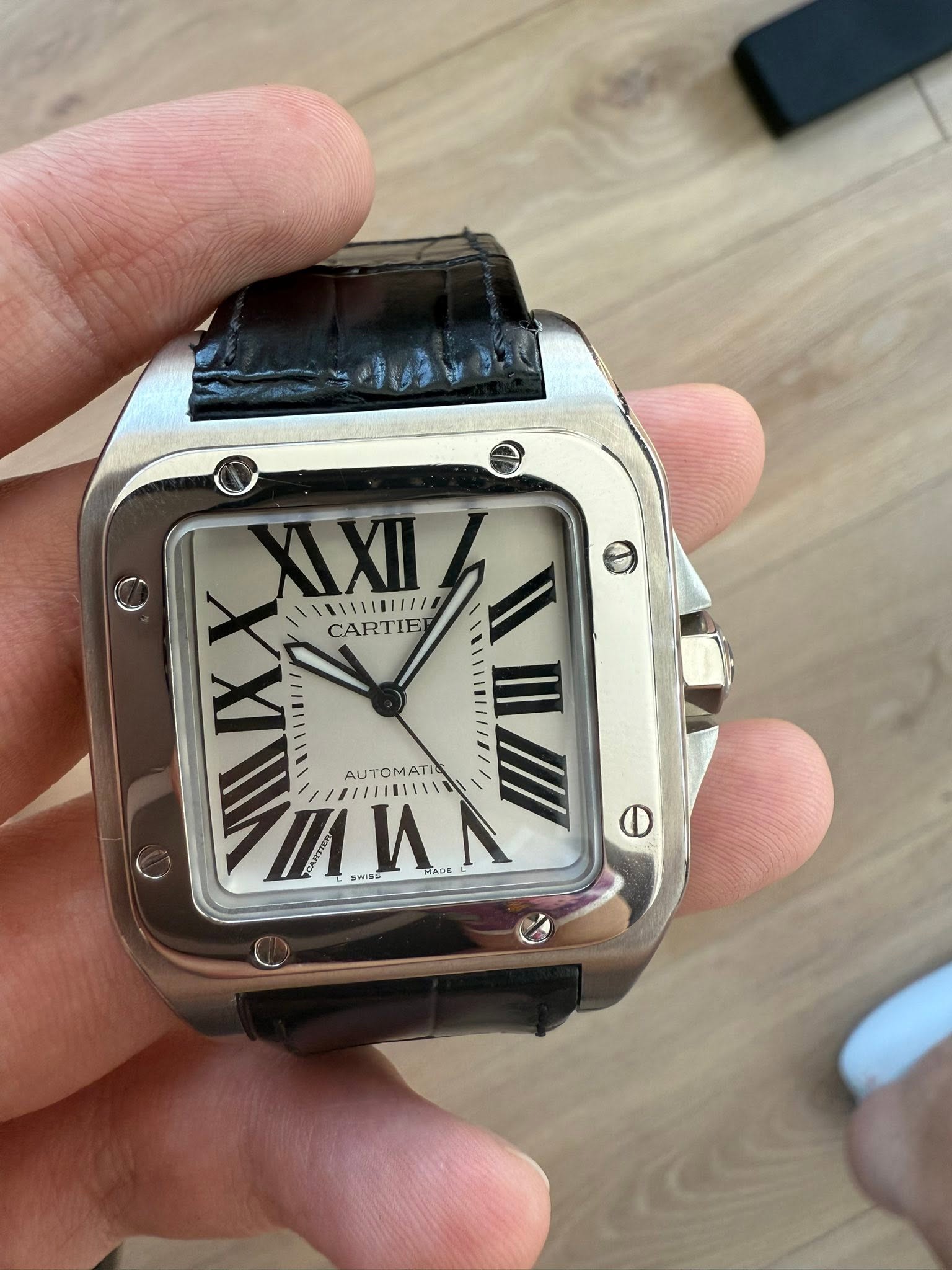May be an image of wrist watch and text