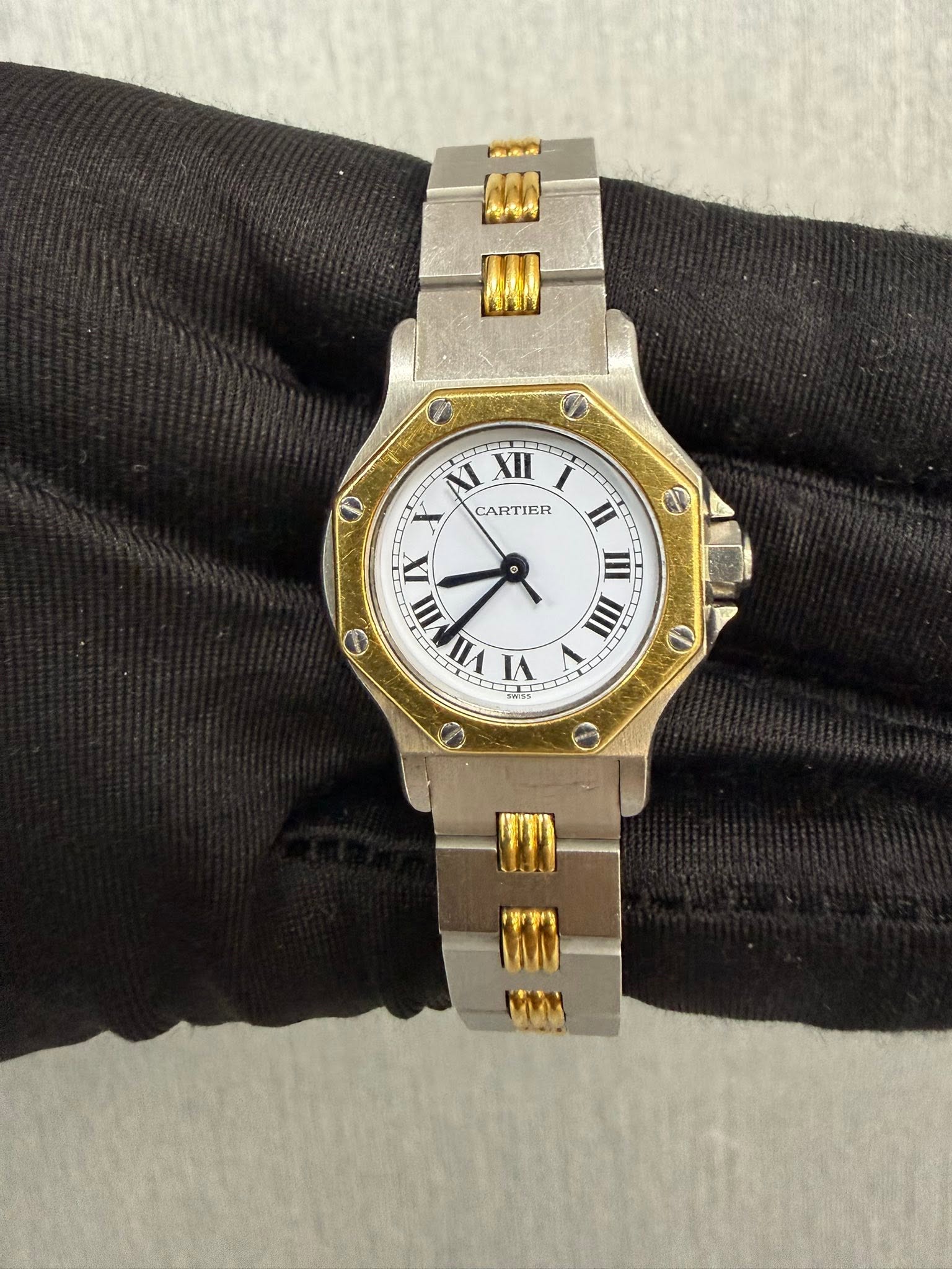 May be an image of wrist watch and text that says 'Man IMA RAA Ι CARTIER ဓ II IIII IX α VII VI D O TEN'