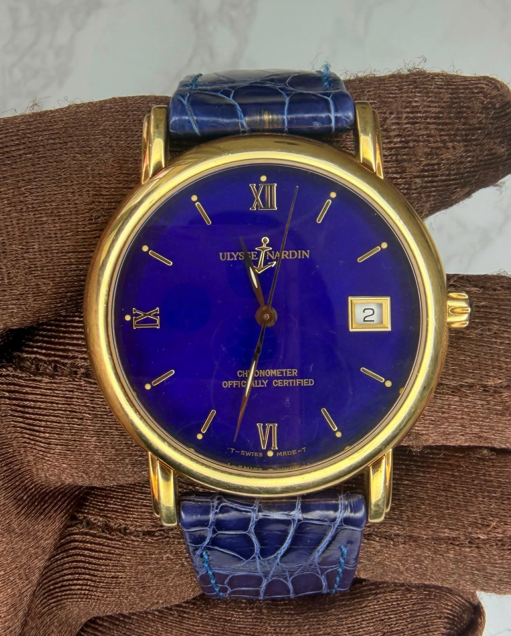 May be an image of wrist watch and text that says 'C ULYS RDIN ARDIN 2 OFFI ULCERTIFIED NGME NOMETER TLY CERTIFIED VI'