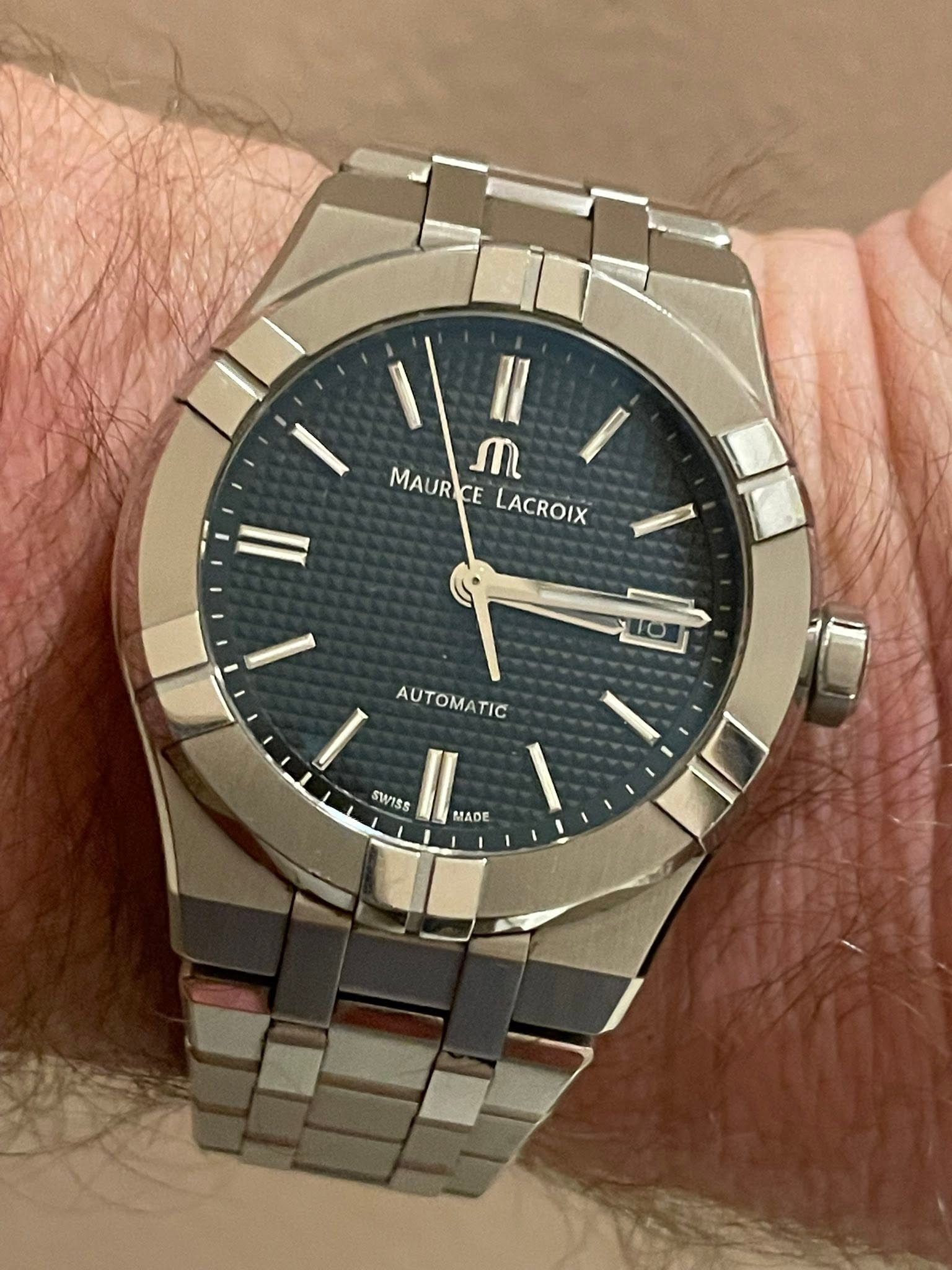 May be an image of wrist watch and text that says 'II ጠ MAURICE CE LACROIX I AUT AUTOMATIC TIC SWISS MADE'