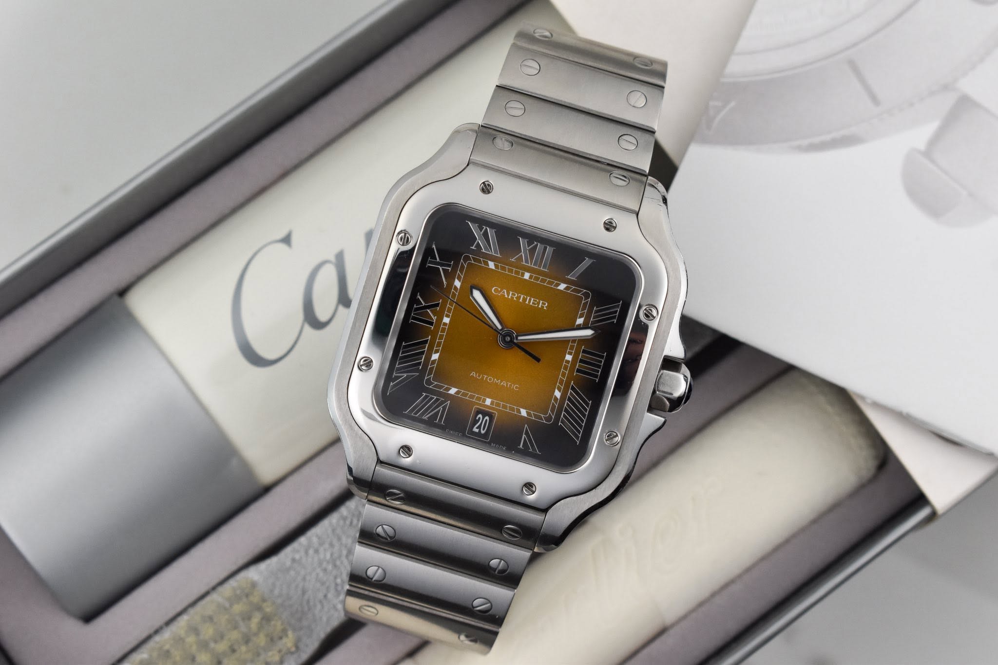 May be an image of digital watch and text that says 'O CARTIER wTOMATC OMAT'