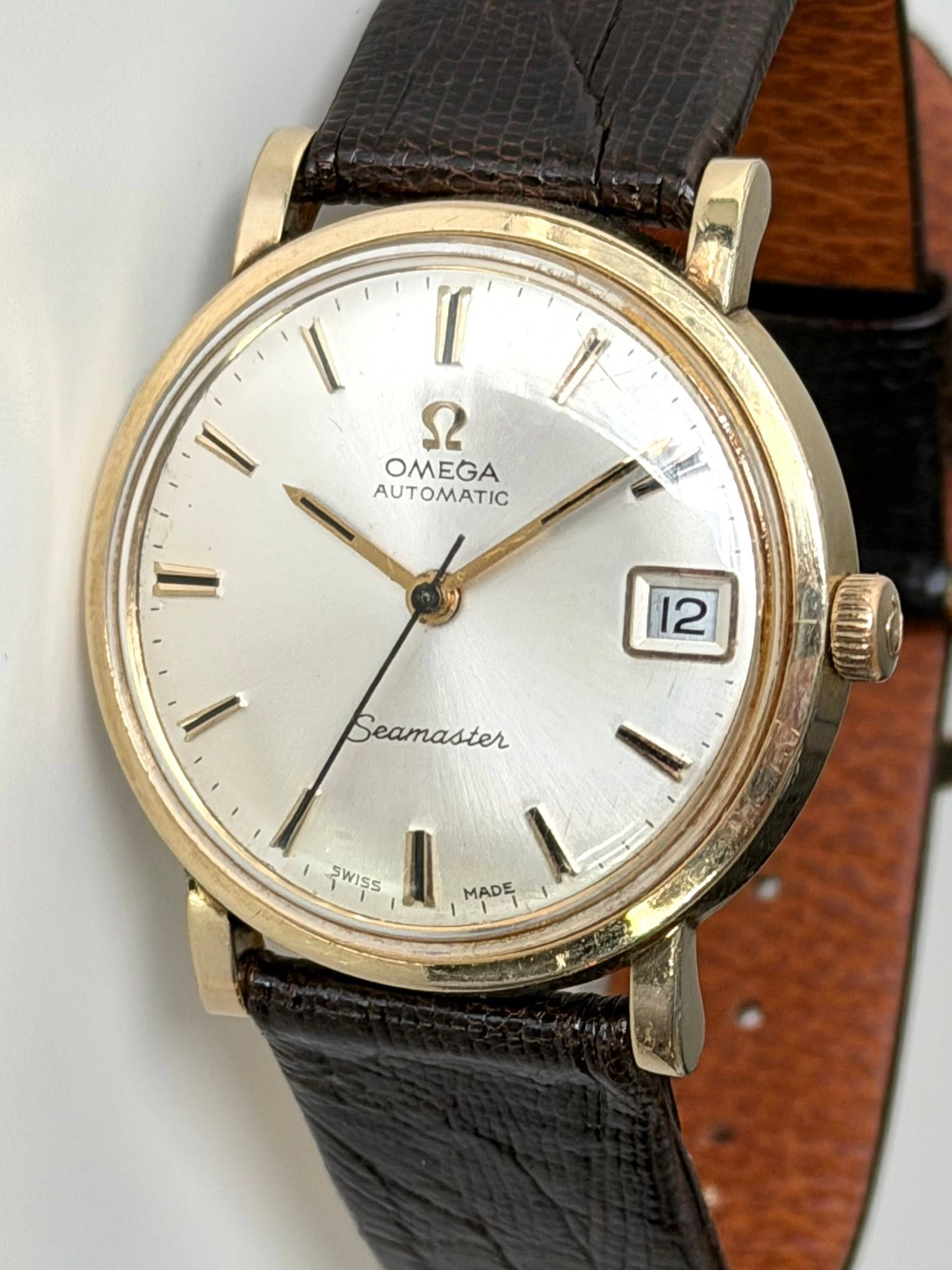 May be an image of wrist watch and text that says '[ ש OMEGA AUTOMATIC 12 Seamaster SWISS MADE'