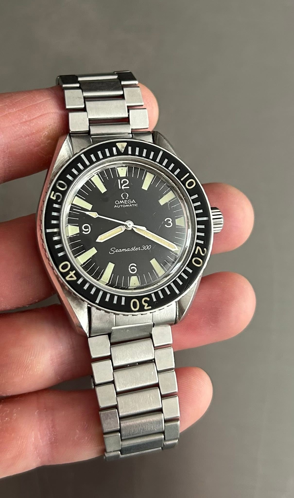 May be an image of wrist watch and text that says '5 O 12 O OMMATC AUTOMATK OMEGA 10 9 3 Seamaster300 stor 300 Seama O 30'
