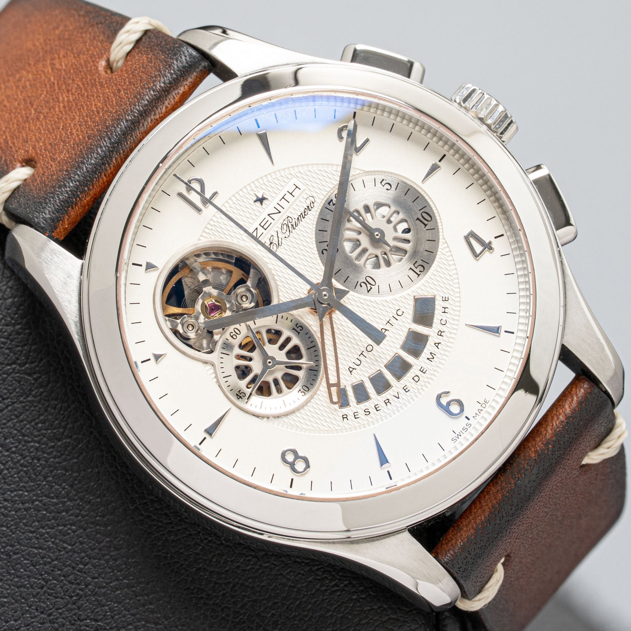 May be an image of wrist watch and text that says 'NOBR 5 12 * ENITH /Shimoro 0 0 20 TIC AUTO 45 OE 15 RCHE M DE E E さ 6 MA6 ADE ΑιόT SWISS HeCdl'