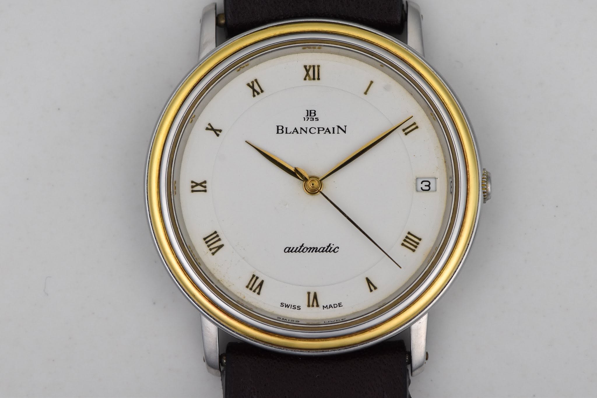 May be an image of wrist watch and text that says 'XII XI I JB 1B 1735 BLANCPAIN X |II IX 3 KUrTE VIII automatic 三 IIA SWISS ΙΛ MADE'