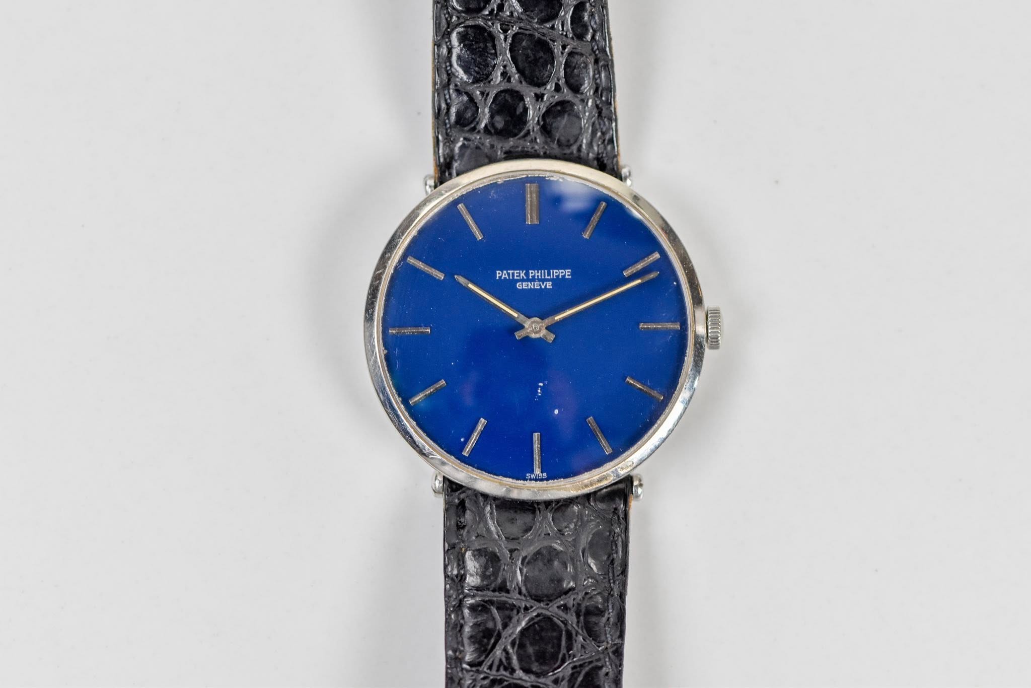 May be an image of leather, wrist watch and text