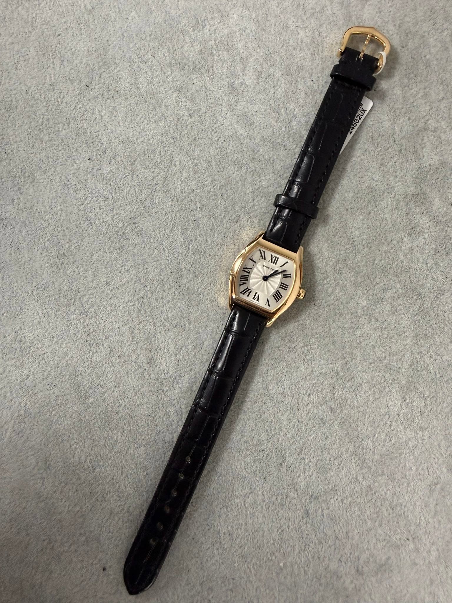 May be an image of leather, wrist watch and text that says 'XI I XII I 1 n A d'