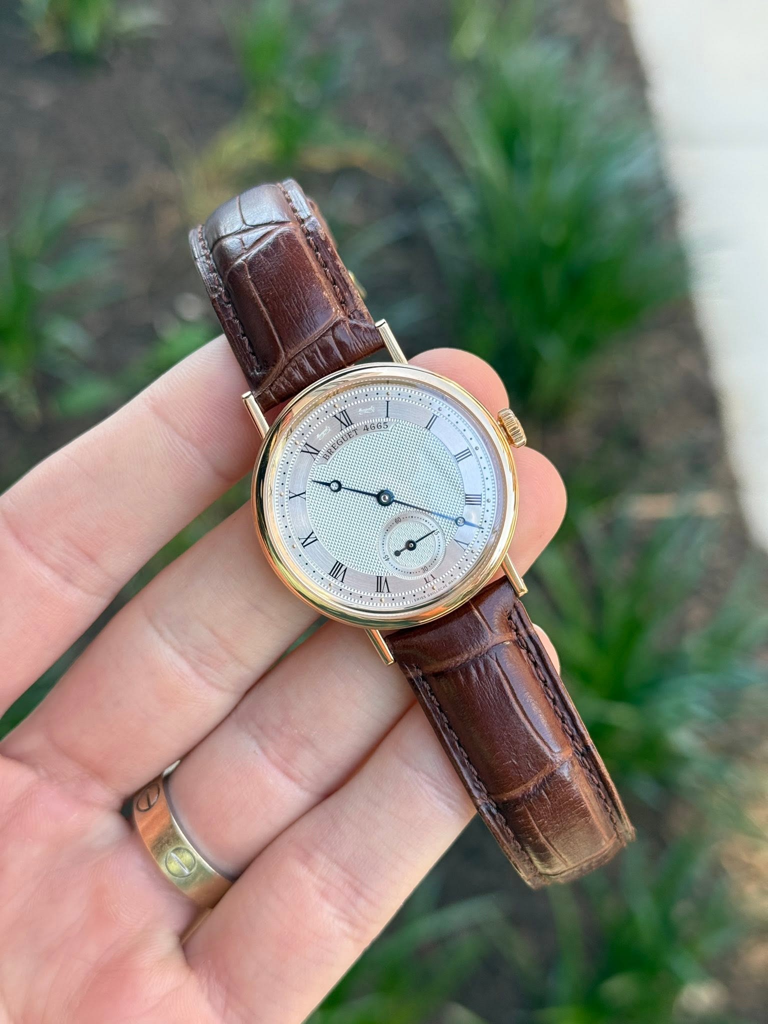 May be an image of wrist watch and text