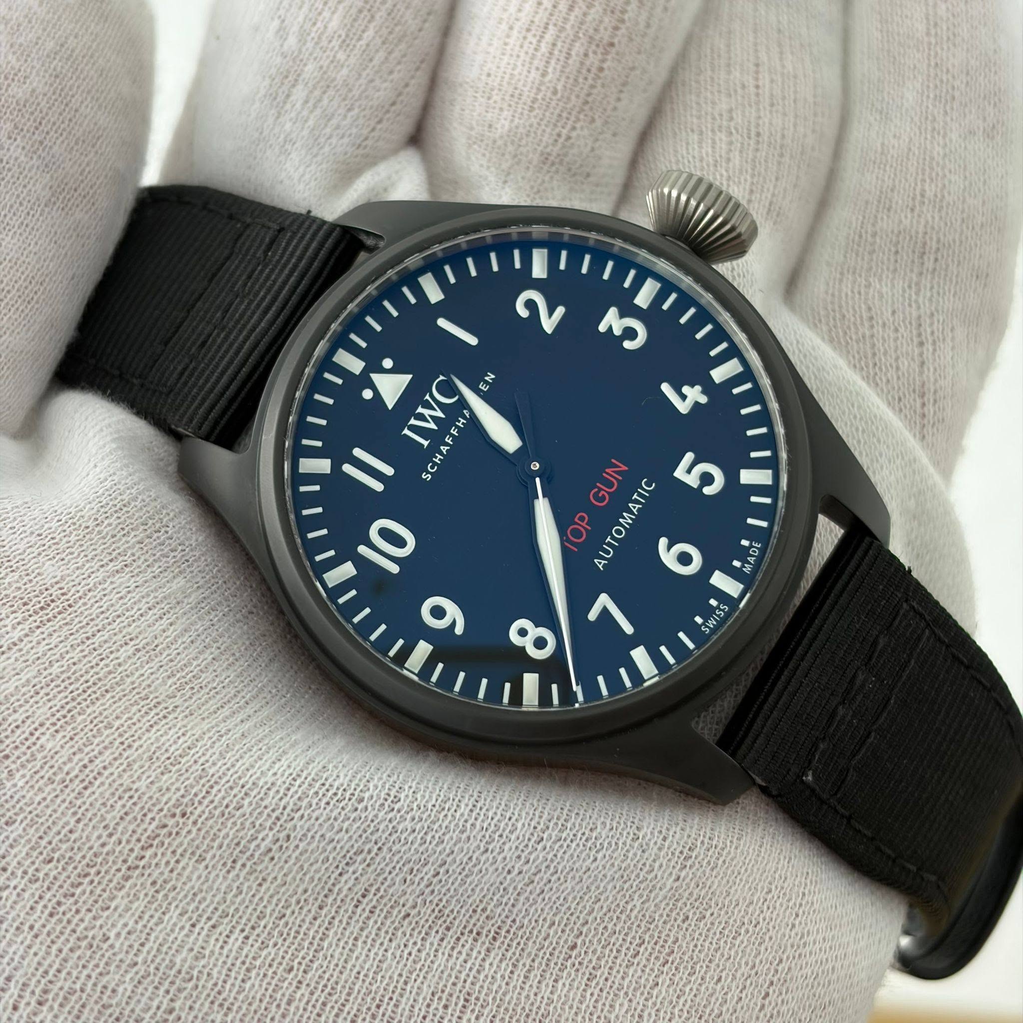 May be an image of wrist watch and text that says 'IWC ر FHA EN EN 11 SCH 0 ن M さ GUN 5 OP AUTOMATIC AUTOMATI 6 MADE 7 SWISS 133 4'