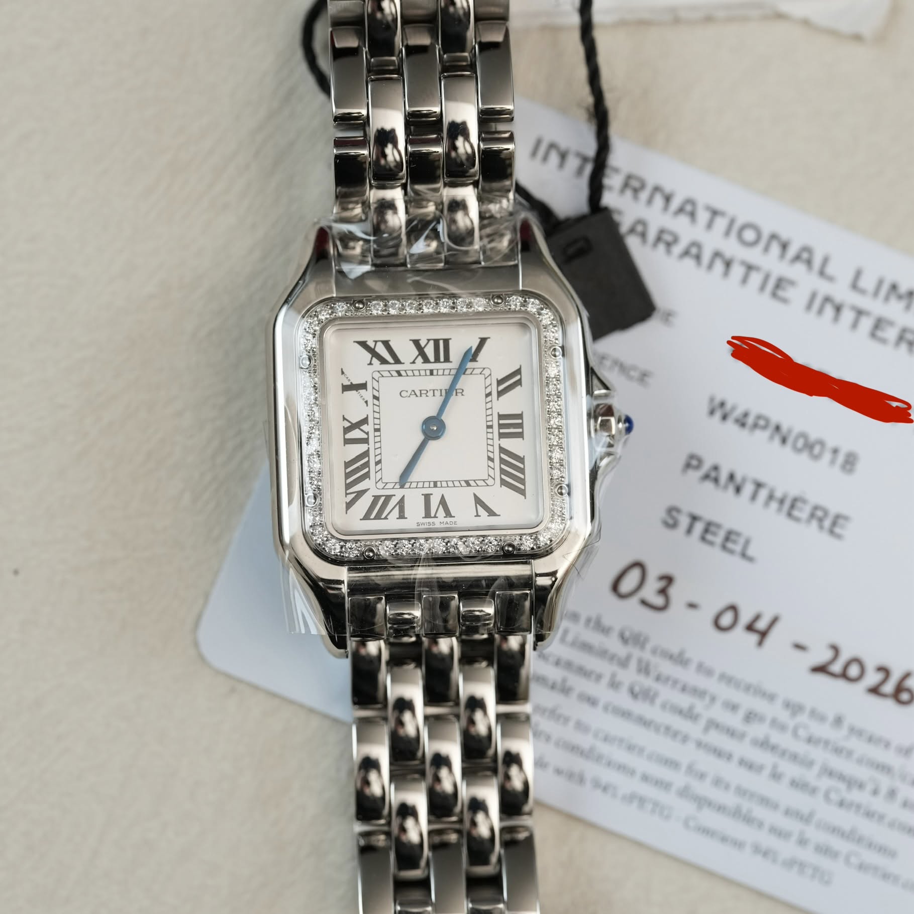 May be an image of wrist watch and text that says 'X XI XII STITND 24 CARTI CARTITR ၁ XI اله TA I INT ARANTIE RNATIONAL PRATIONAL ARANTIE INTER INTER LIM W4PN0018 STEEL STEEL…