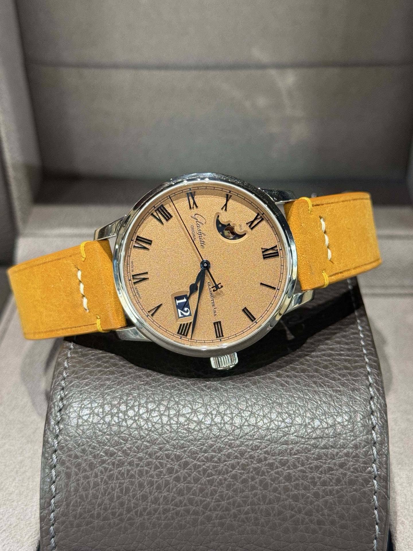 May be an image of wrist watch, leather and text