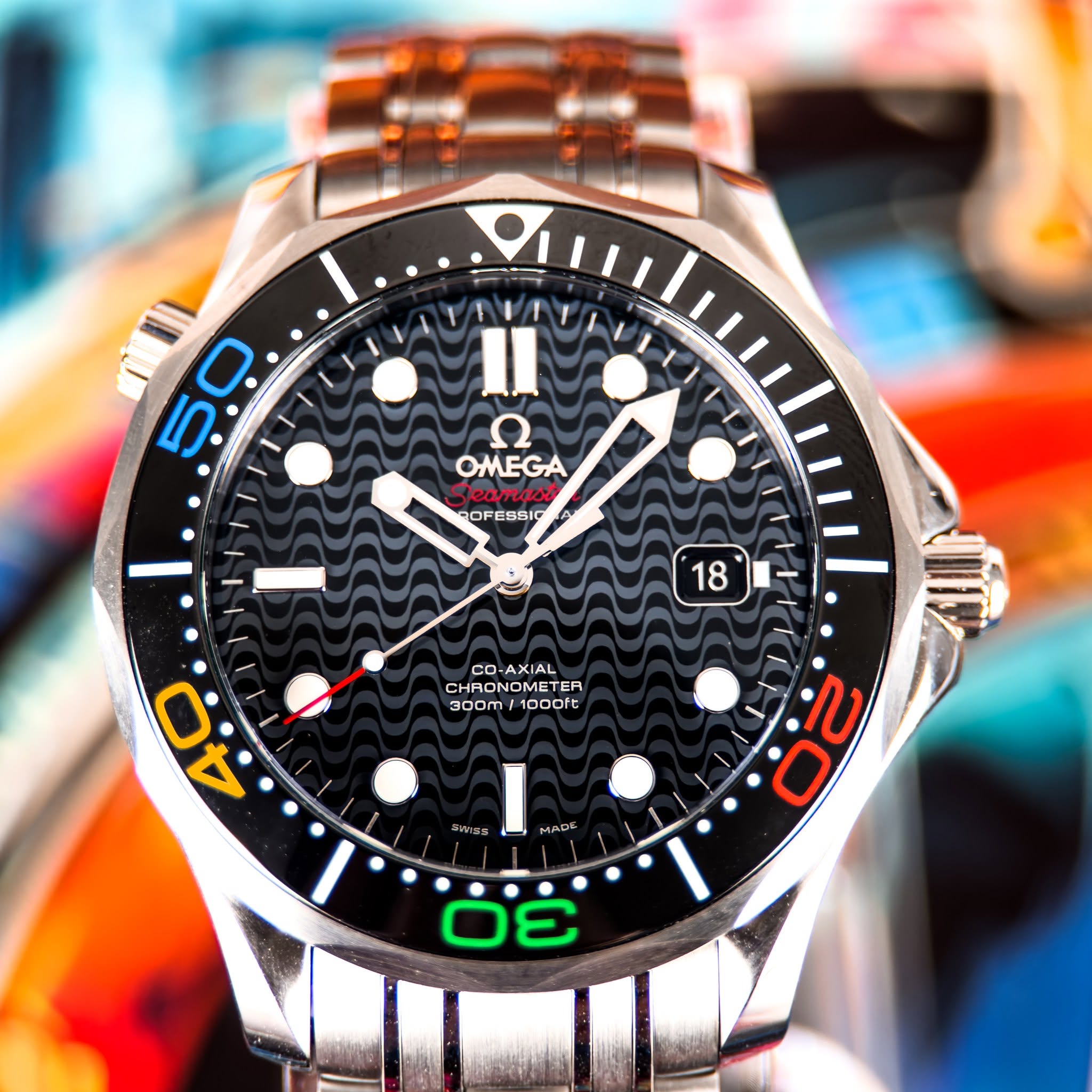 May be an image of wrist watch and text that says '5 0ف 0 OMEGA cBc eamasi s RO ROFESSIC OFE 18 18 CO-AXIAL CHRONOME CHRONOMETER TER 300m/1000ft 1000ft 300m ب KWzS MADA 0 3'