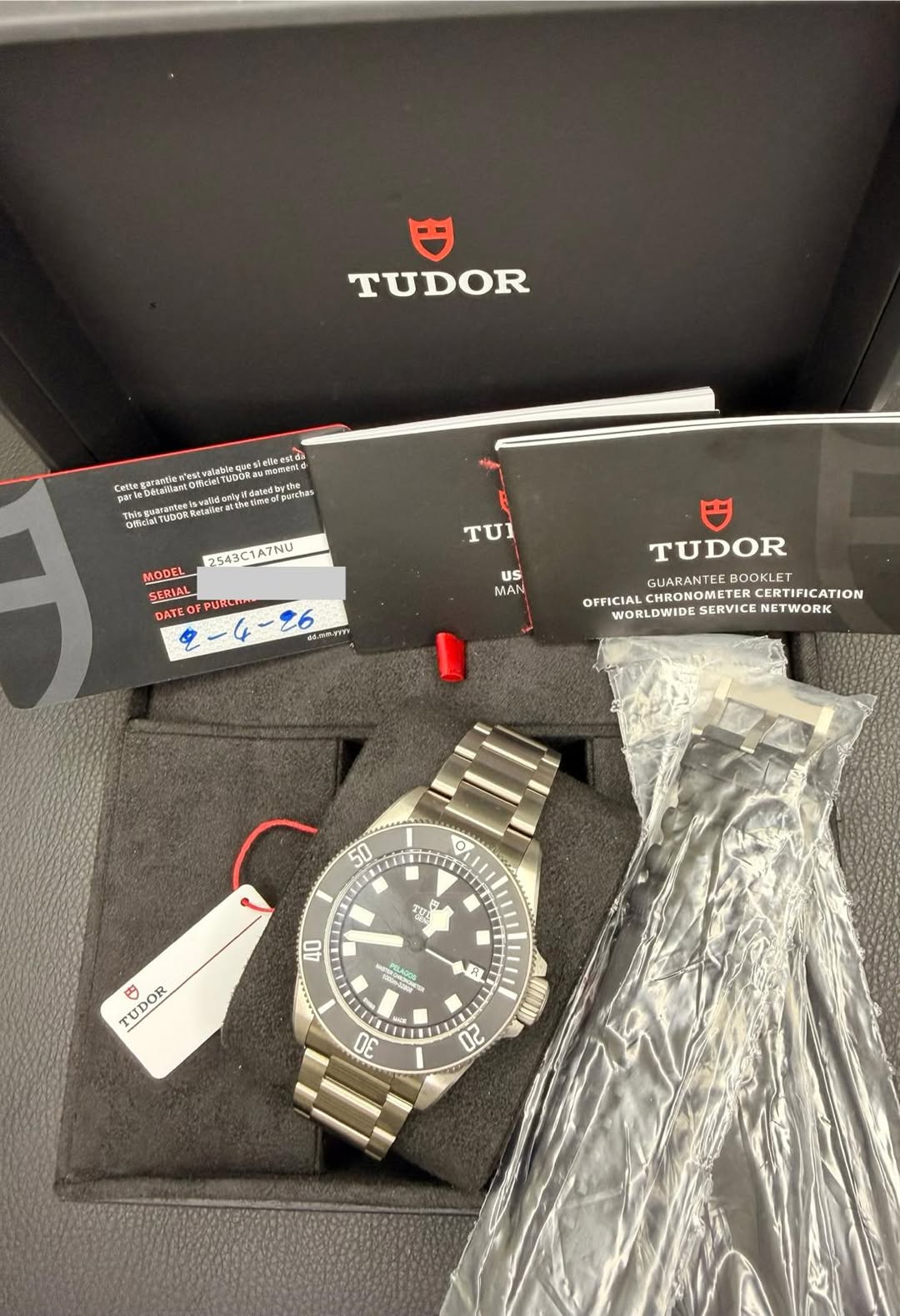 May be an image of wrist watch and text that says 'TUDOR Ofkia wwewghta/iarairetyす TUI 2543C1A7NU MODEL SERIAL DATEOFPURCI 2-4-26 ፍፍቅበያያ DATEO US MAN TUDOR GUARANTEE BOOKLET…