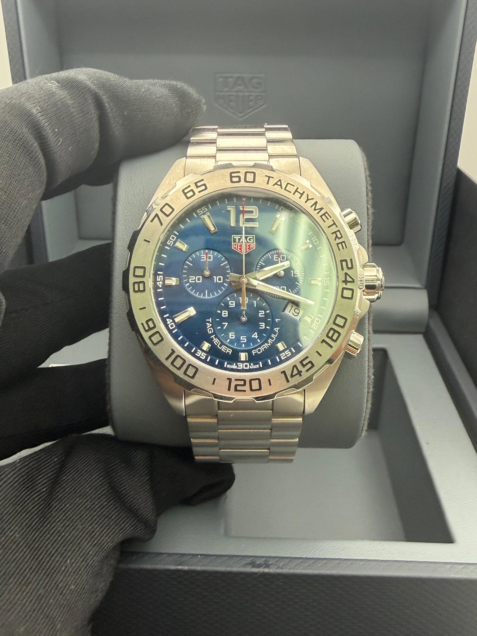 May be an image of wrist watch and text that says ' ® 60 TACHYMETRE FACOALC 12 TAG HE E0 15 9 240 B 06 40 B 35 HELER JER 6 6 FORMUL 4 ORMU 25 C5 A 145 08L 9 5 I30O ni 19'