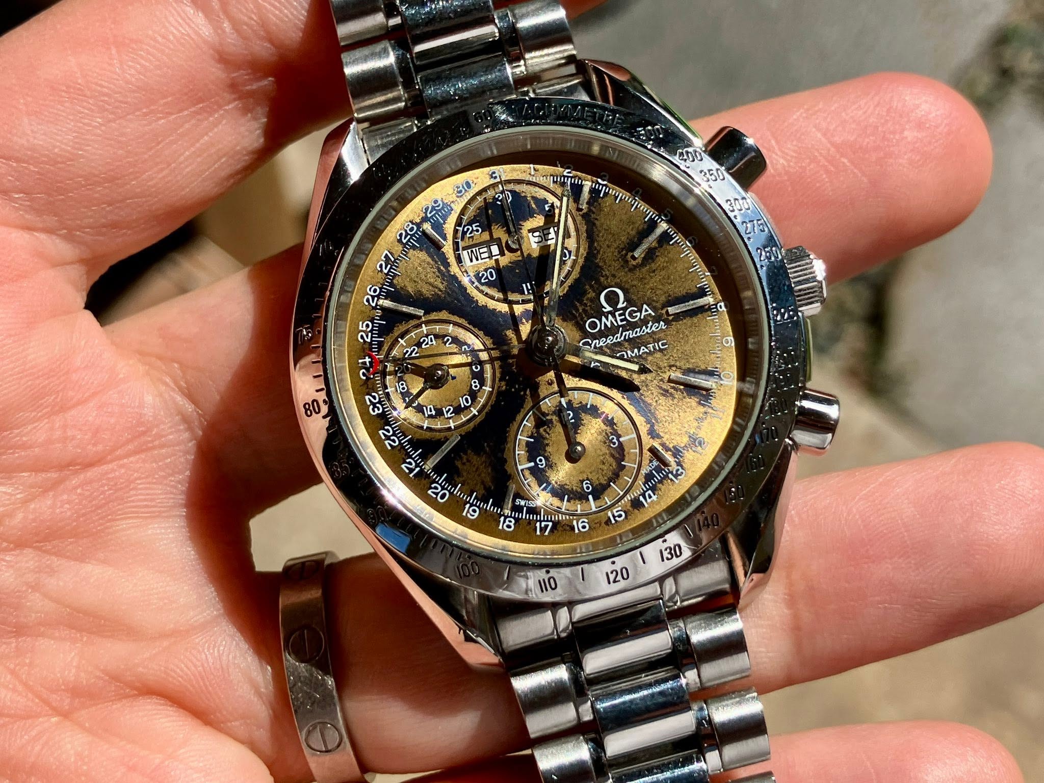 May be an image of wrist watch and text that says '400 350 E WE 20 18 A 2 Ee. നி 1B0 24 3 10 ਟੇਟ 12 20 19 Sreedmasier MATIC OMEGA ه B I 0 9 6 18 Taoes 5 6 ጣካን Cν '