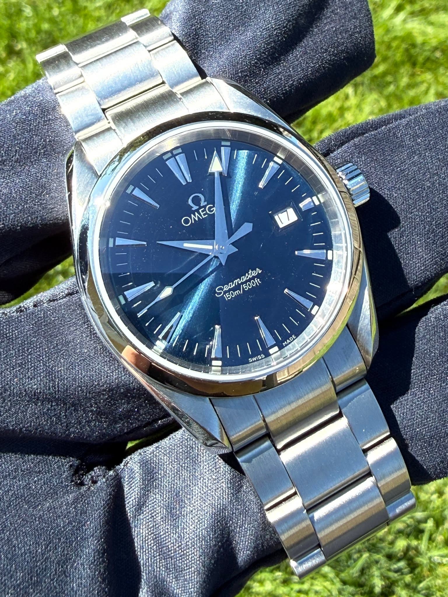May be an image of wrist watch and text that says 'OMEG OMEG S Seamaster Seamabon A naster 500ft 150m/ ي MADE MADE SWISS po'