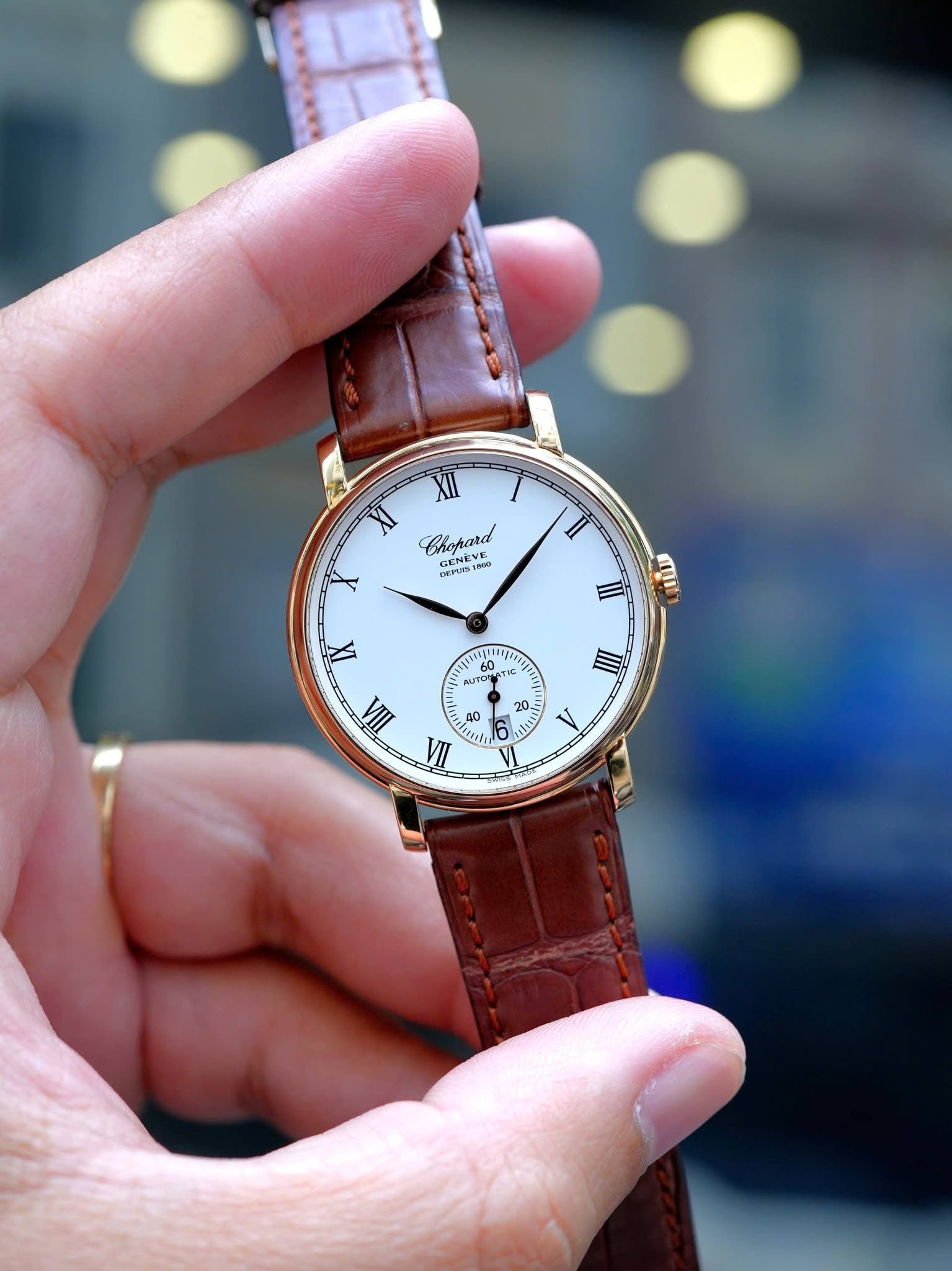 May be an image of leather, wrist watch and text