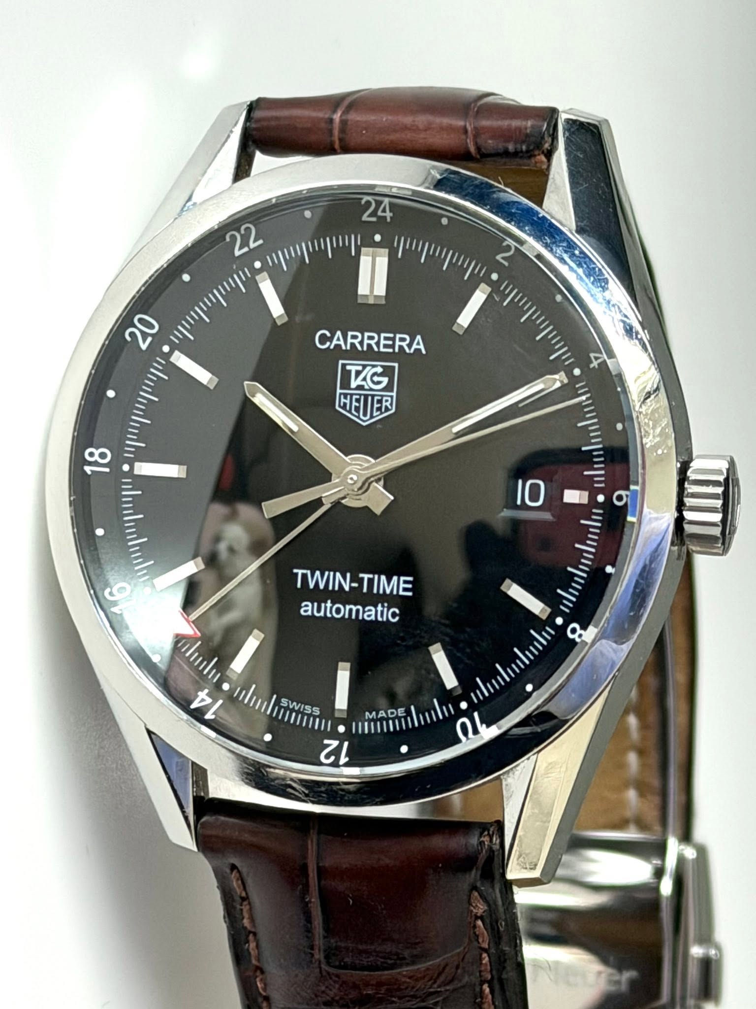 May be an image of wrist watch and text