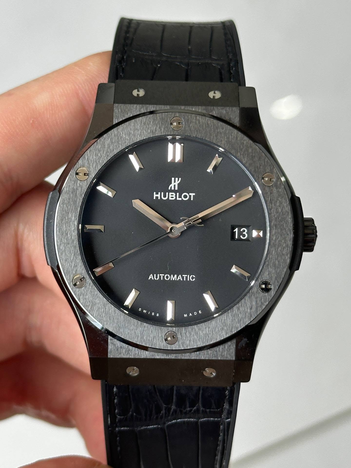 May be an image of wrist watch and text that says 'K HUBLOT 13 13 A AUTOMATIC wま MADE'
