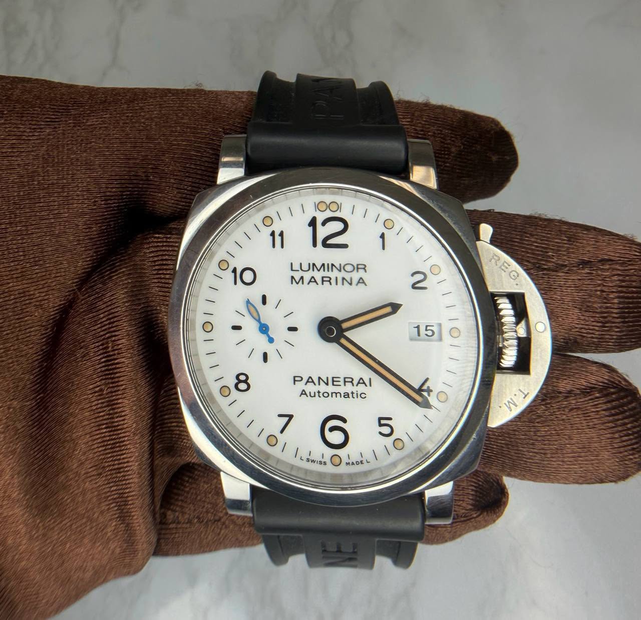 May be an image of wrist watch, leather and text