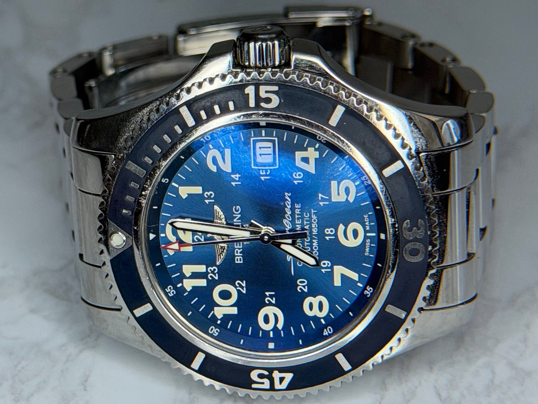 May be an image of wrist watch and text that says 'CAOI 5 15 10 ۷ T ኢወራ Boean METRE 1650FT 18 O MADE 17 5 94 ING 2 NTC BOM/ SWISS ၈ 23 3金 BRE 19 7 35 に 20 ထ 09 40 GV 4'