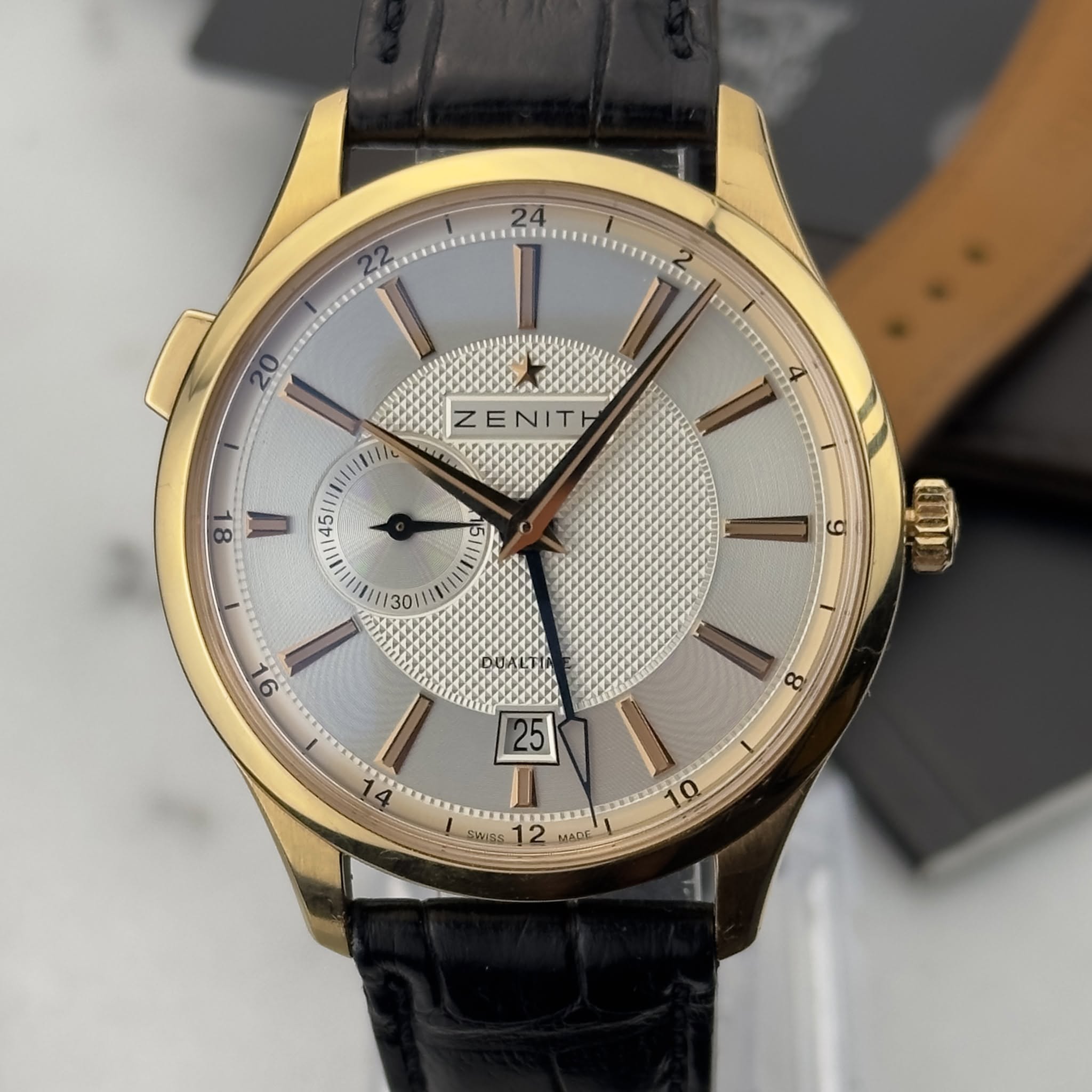 May be an image of wrist watch and text that says 'כוד 2 ZENITH 4 8 45 g ጠ 9 8 BLLH Wins CUrS 12 MADE D'