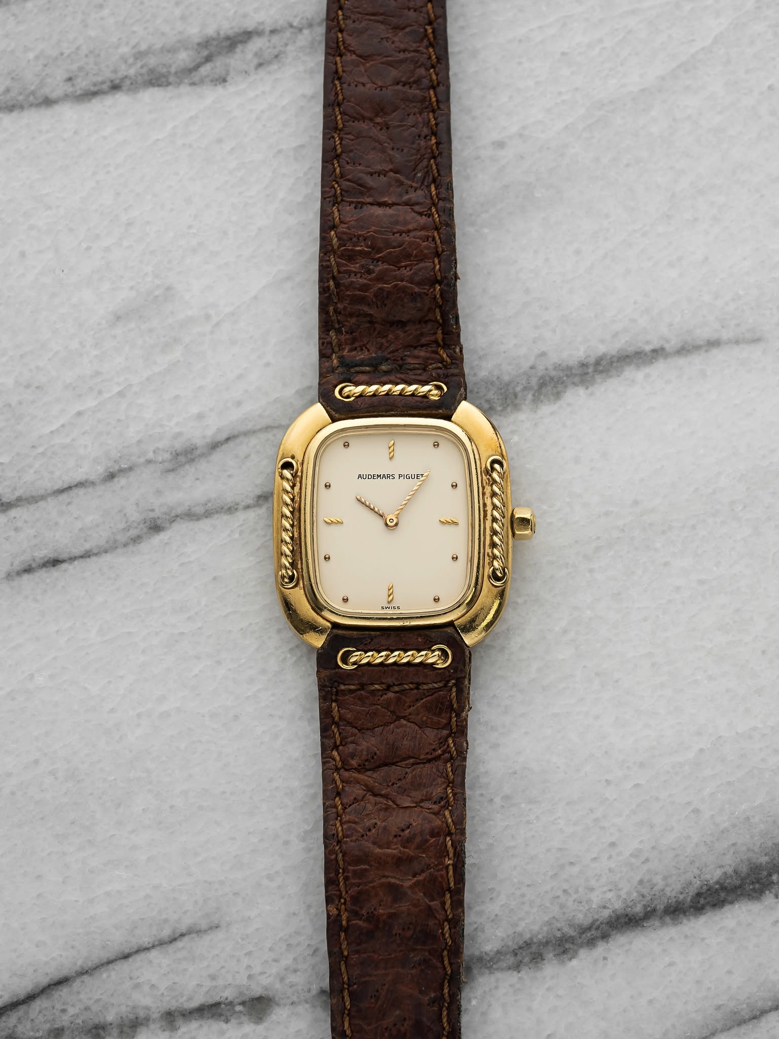 May be an image of wrist watch, leather and text