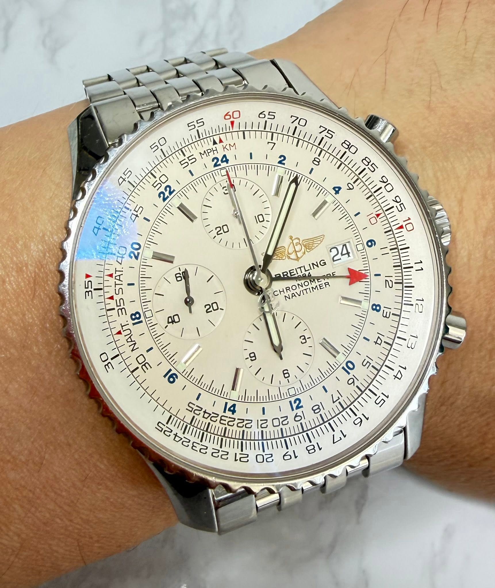 May be an image of wrist watch and text that says ' MPH KM و ٥ 6 監 20- 24 AREITLING HRONOMERO RONOMEIOE NAVITIMER E 八 35 5STAT. 35 18 NAUT 30 30 91 uetululu 22222255 ١ 14 12 ထဲ…