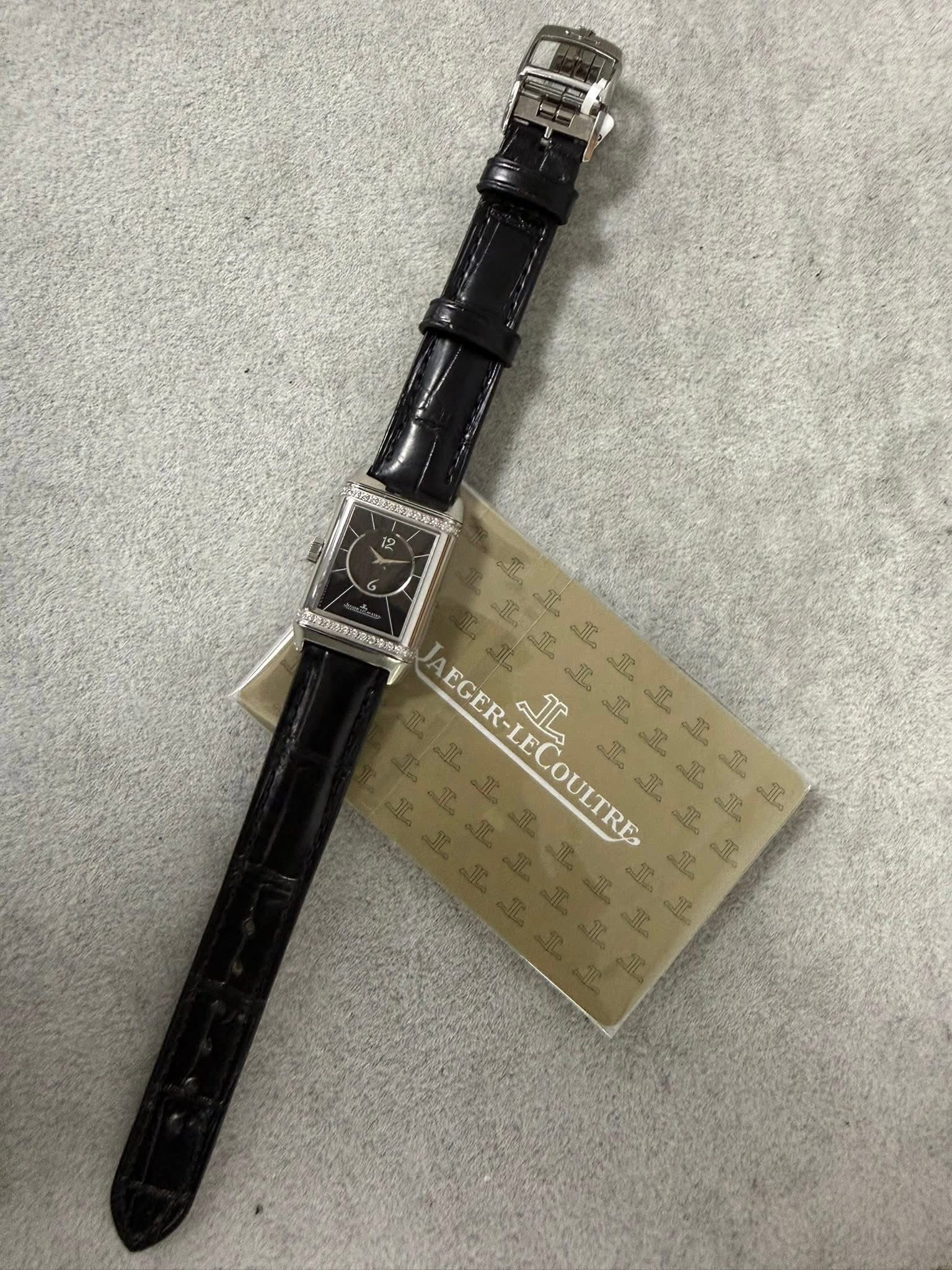 May be an image of wrist watch, leather and text