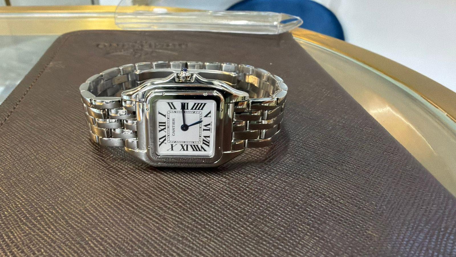 May be an image of wrist watch and text