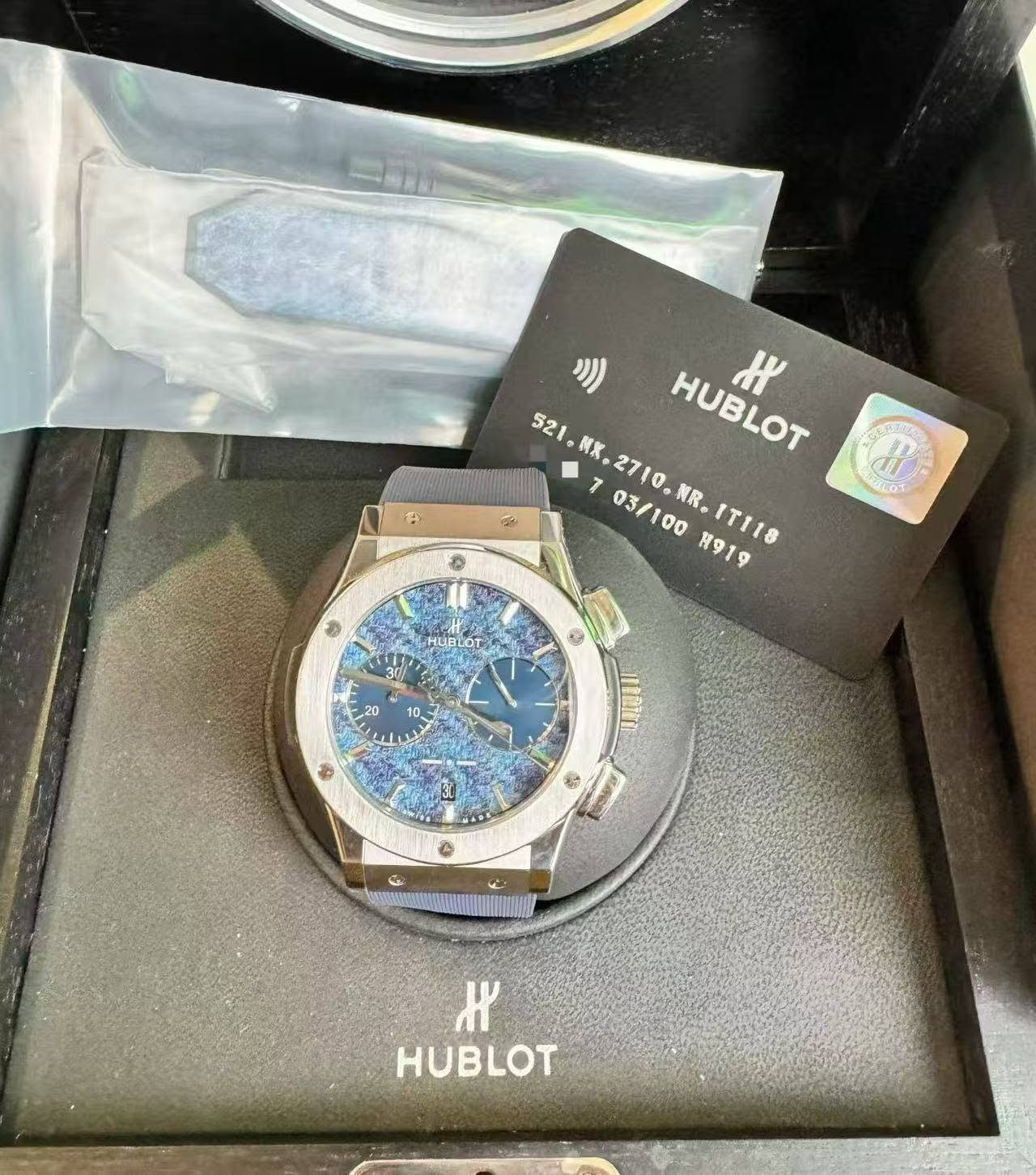 May be an image of wrist watch and text that says '9 521 HUBLOT ዞ 2 521,RK.2710.AR.1T118 703/100 7 NK .2710. 03/100 R。 R919 IT118 @ OS t ශරී HUBLOT ۱ 20 10 9 D 10N 30 福 ٣۳ HUBLOT'