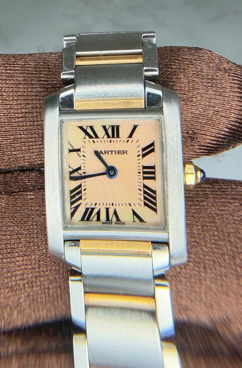 May be an image of wrist watch and text