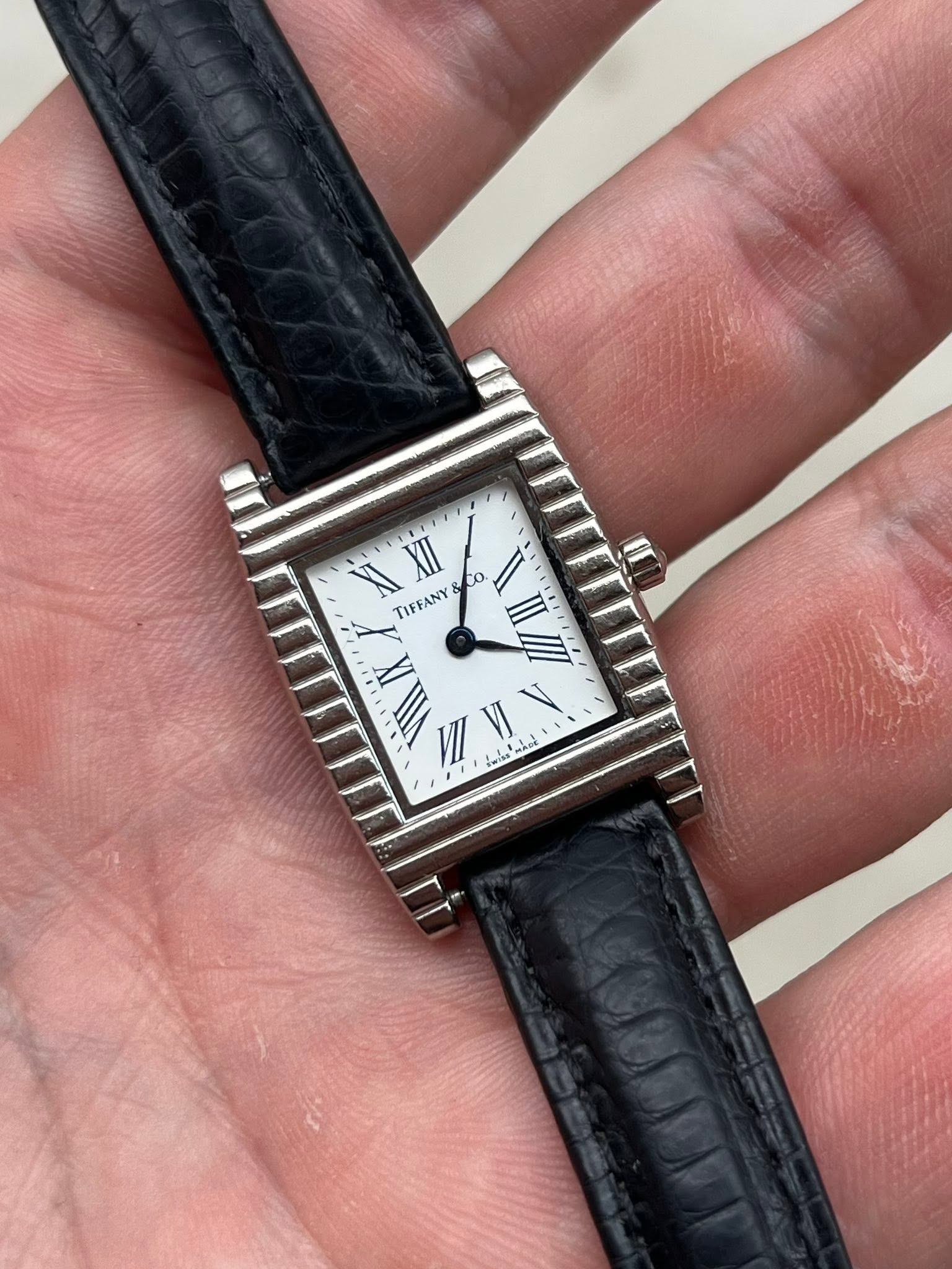 May be an image of wrist watch and text that says 'XI co O. 0. TIFFANY II II II ن !uise MADE И دـ'