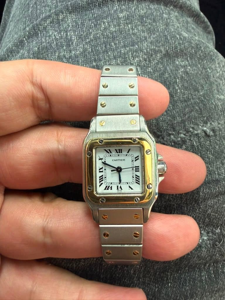 May be an image of wrist watch and text