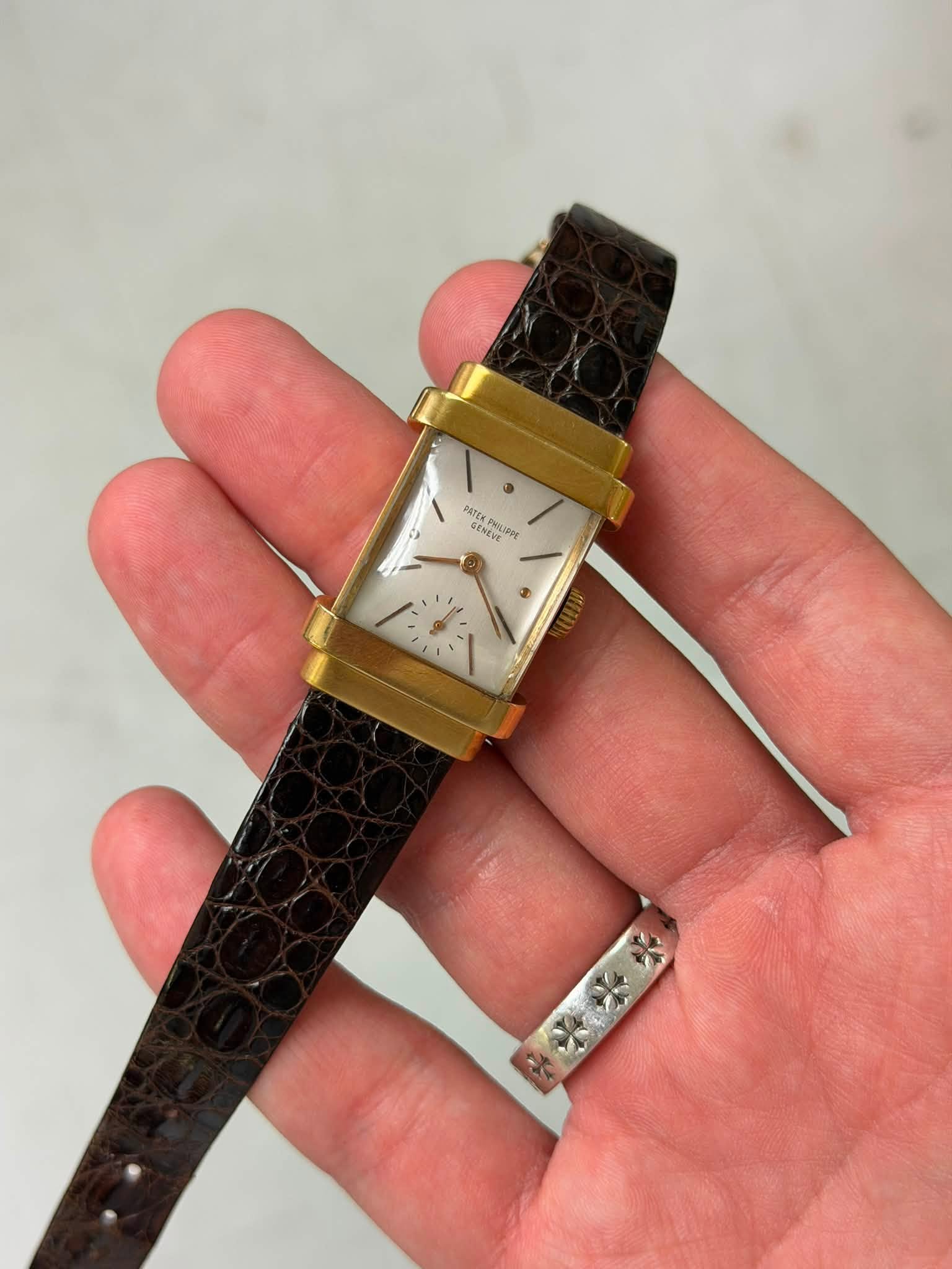 May be an image of wrist watch and text
