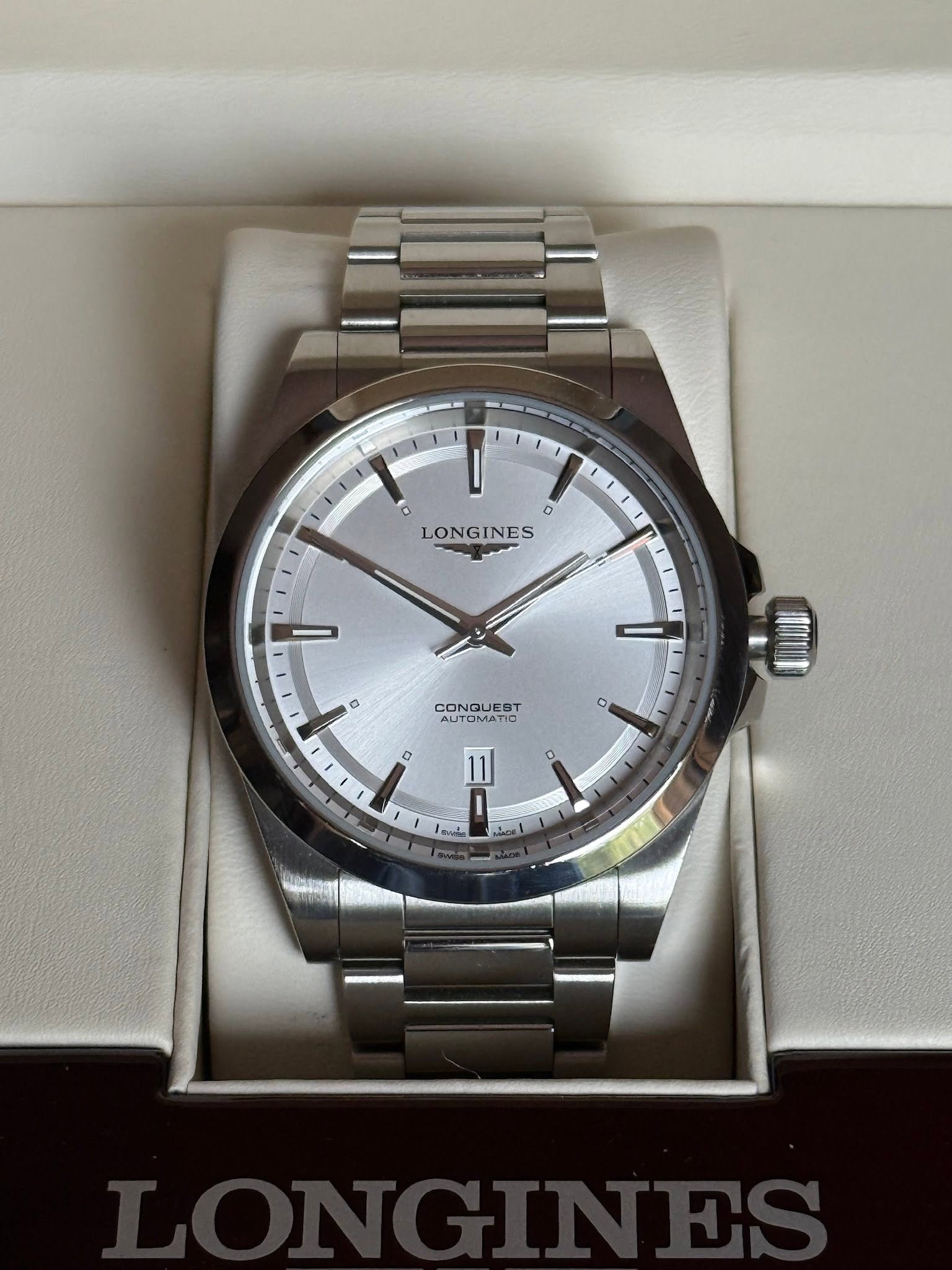 May be an image of wrist watch and text that says 'o LONGINES a CONQUES EST AUTOMATIC CUTOMATID AUTO O'