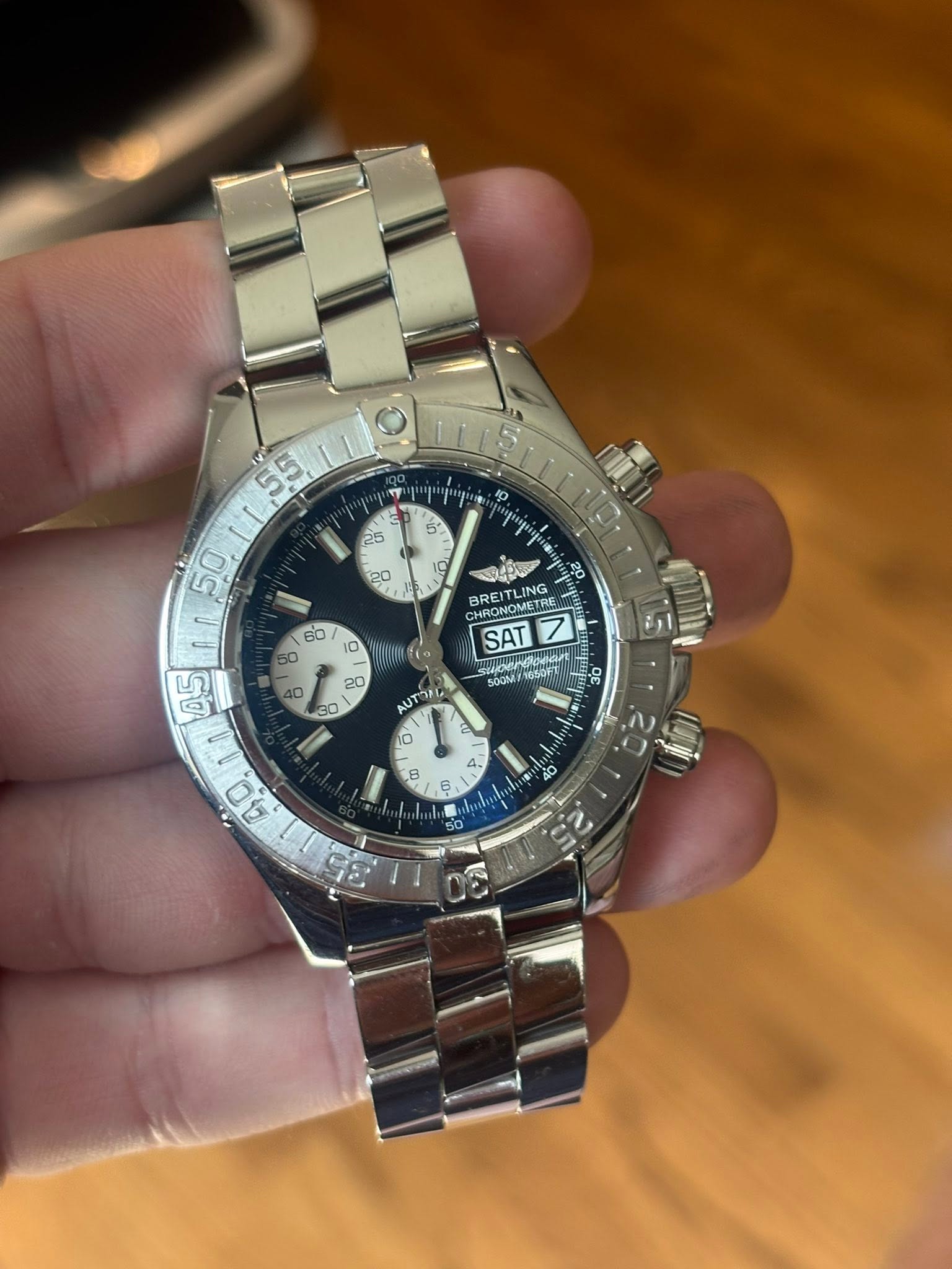 May be an image of wrist watch and text