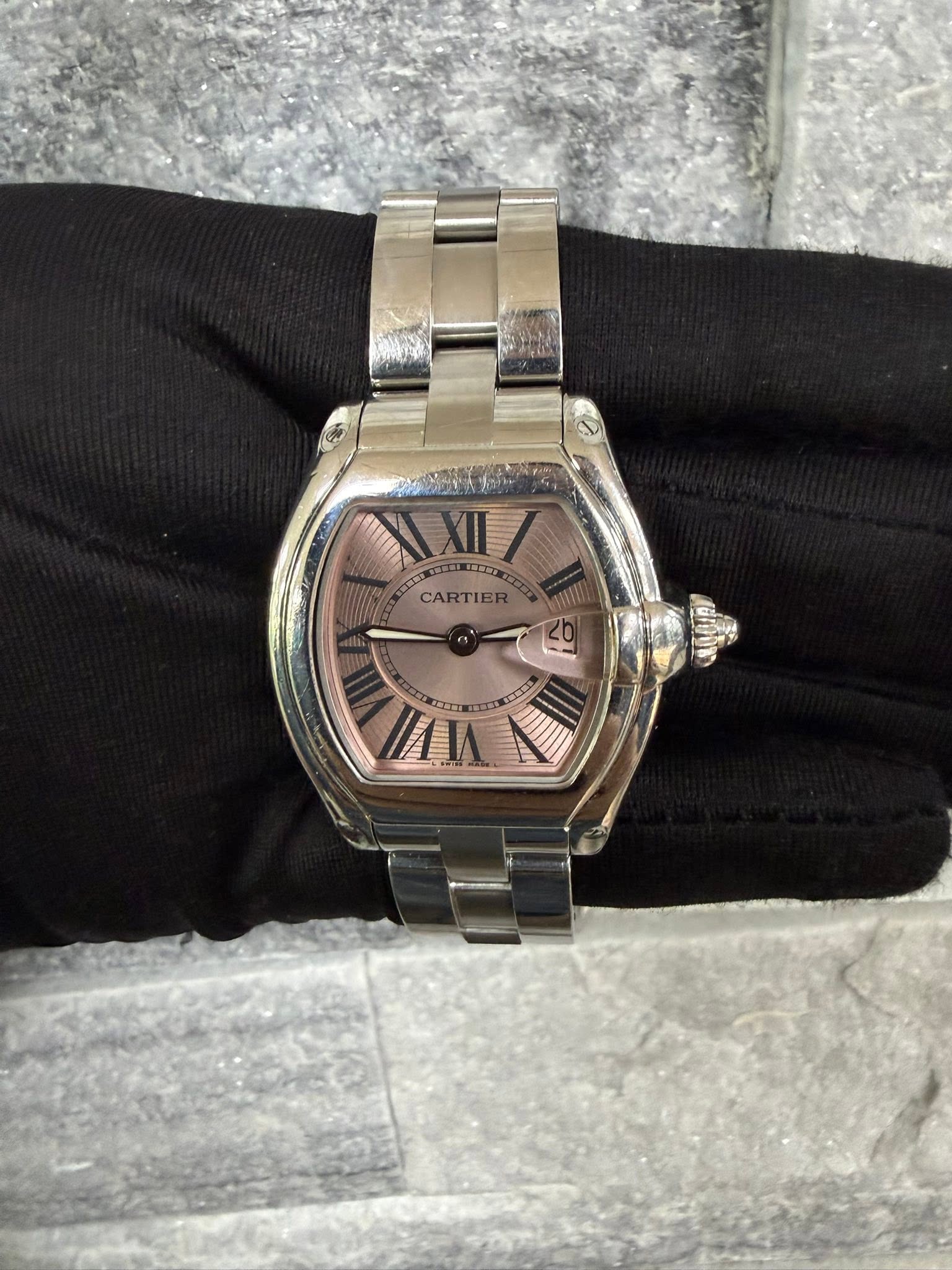 May be an image of wrist watch and text